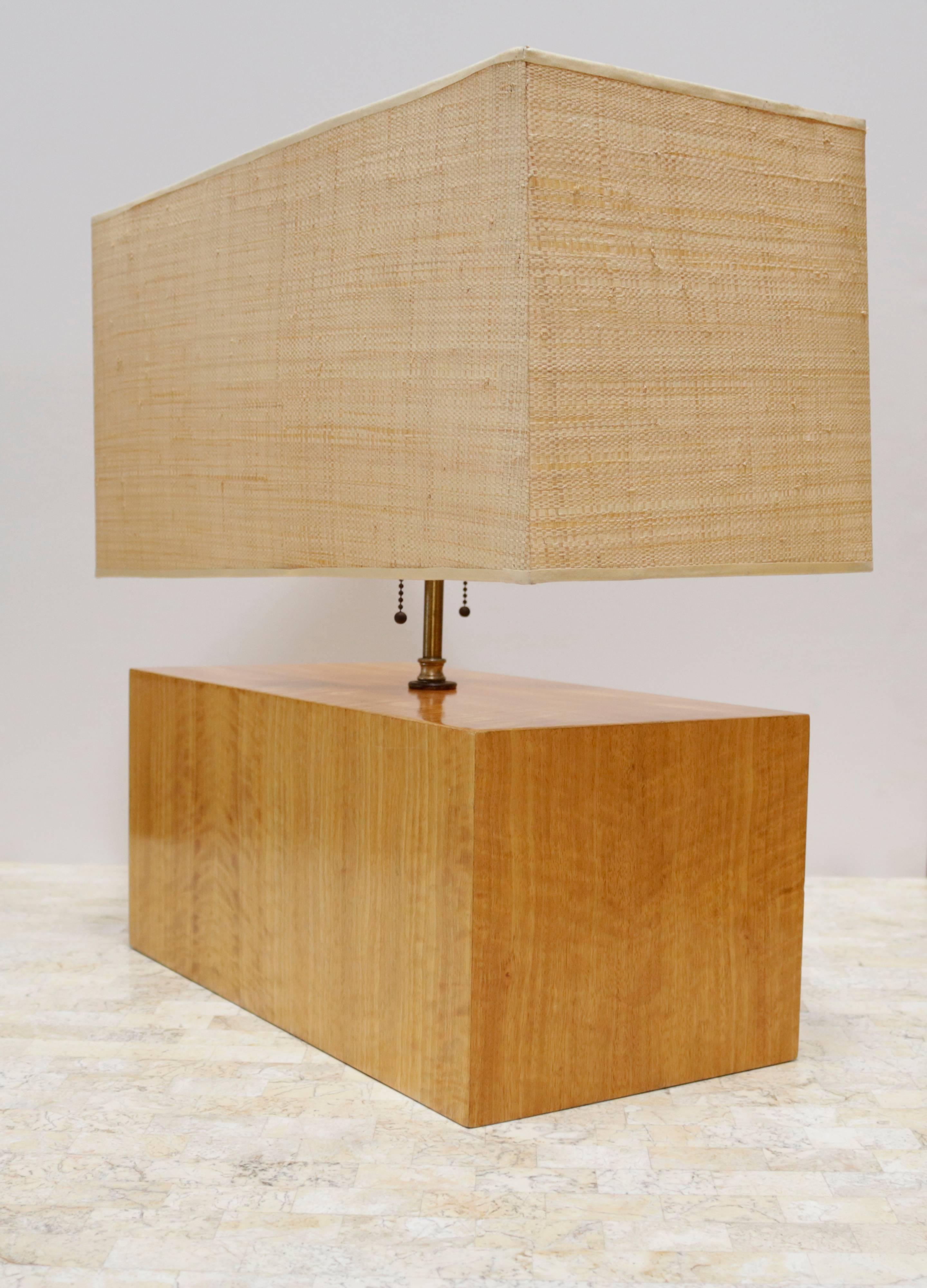 Rectangular zebra wood table lamp with original woven shade. Made of lustrous wood that has a highly reflective, almost iridescent grain. Features two lightbulbs and pull chains. Wood base measures 8.0" high.