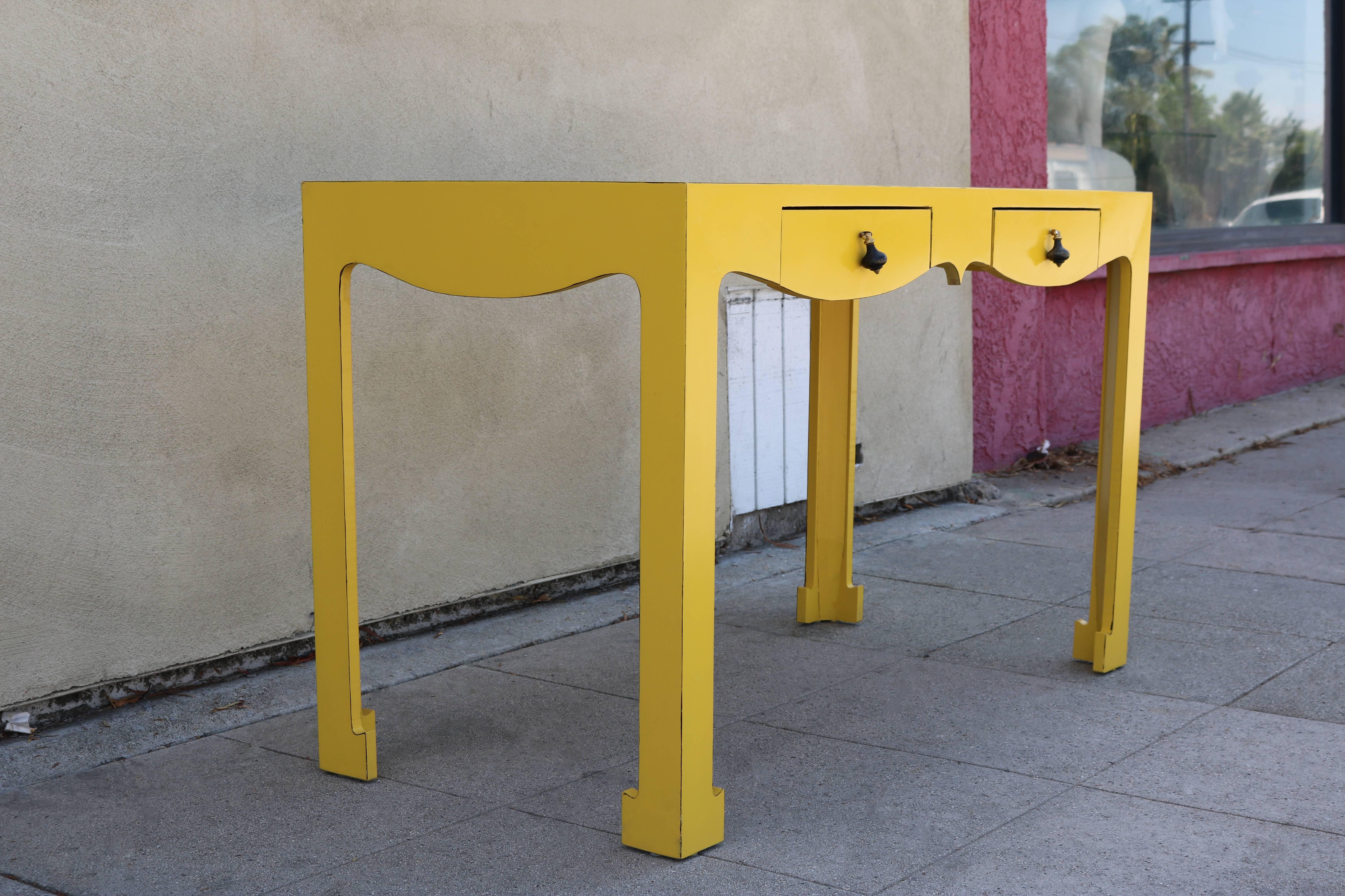 Yellow formica writing desk is very surprising with its scalloped apron, tassel knobs which reminded the style Louis the 14th, the feet shape and the yellow Formica.