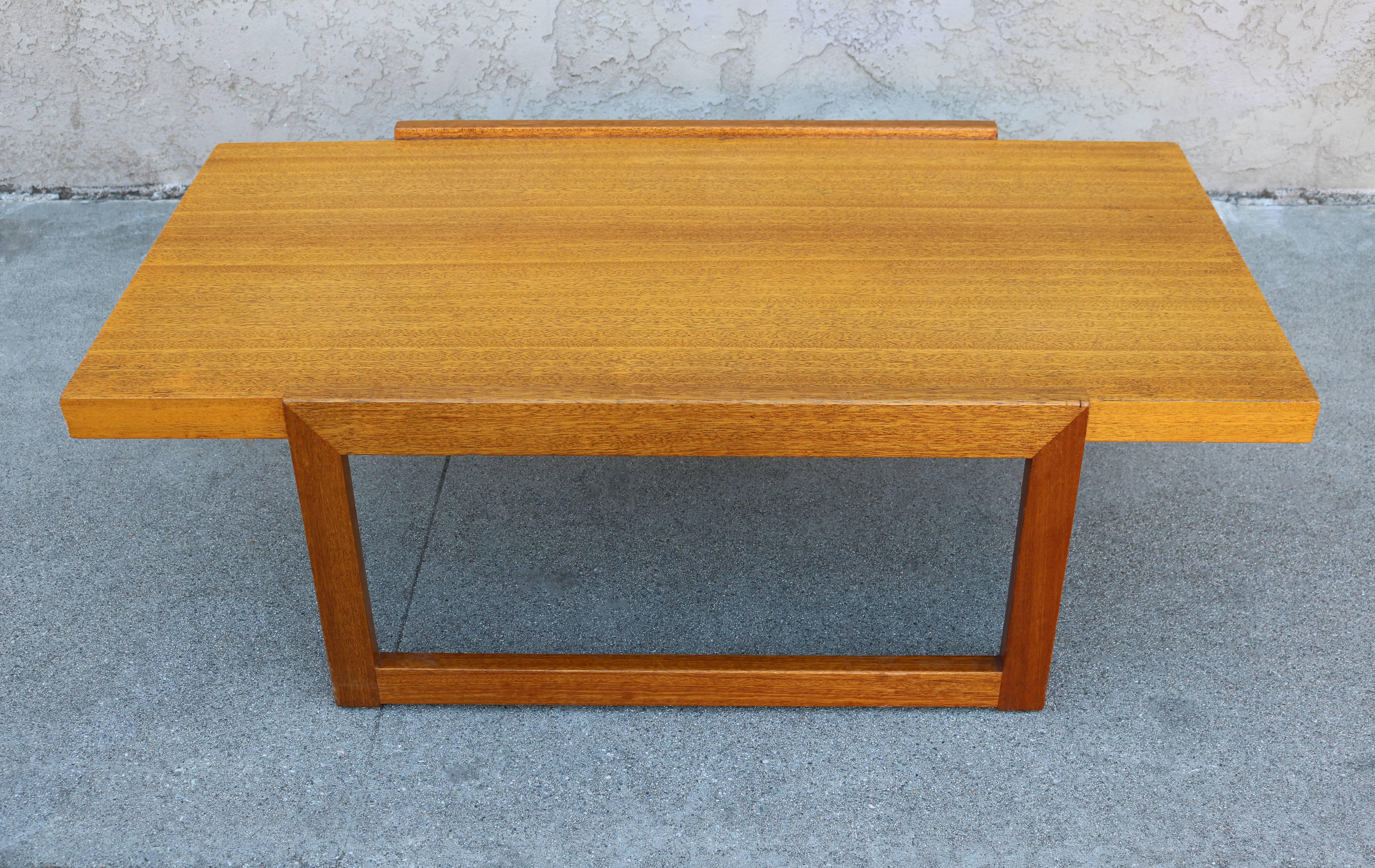 This wooden cocktail or coffee table was designed by the Hungarian modernist architect and designer Paul Laszlo. This piece has Laszlo's signature on underside.
