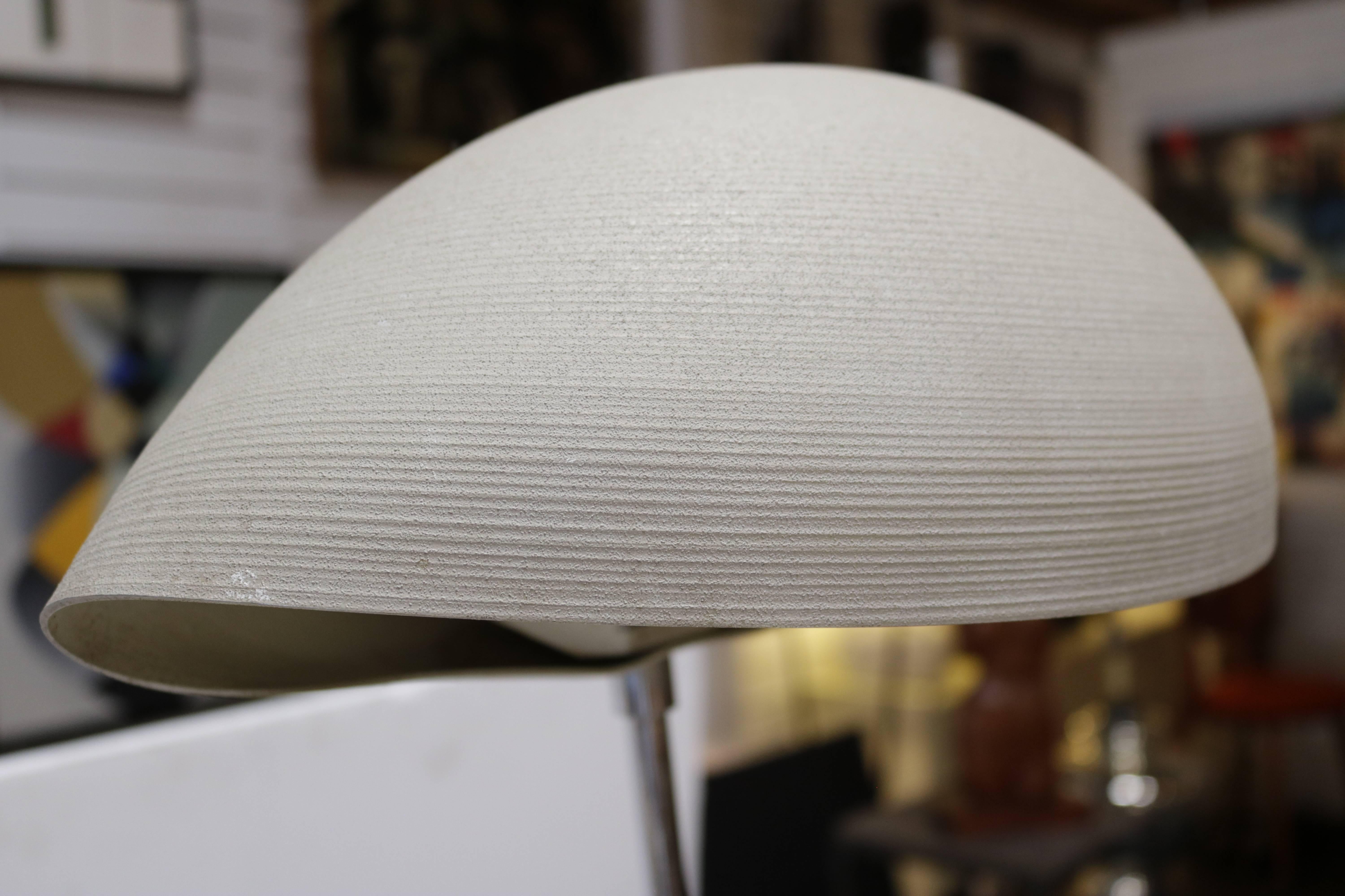 1970s floor lamp with light gray textured shade is painted bent metal with a chrome base. Turns on and off by foot pedal type switch. Has a label for 