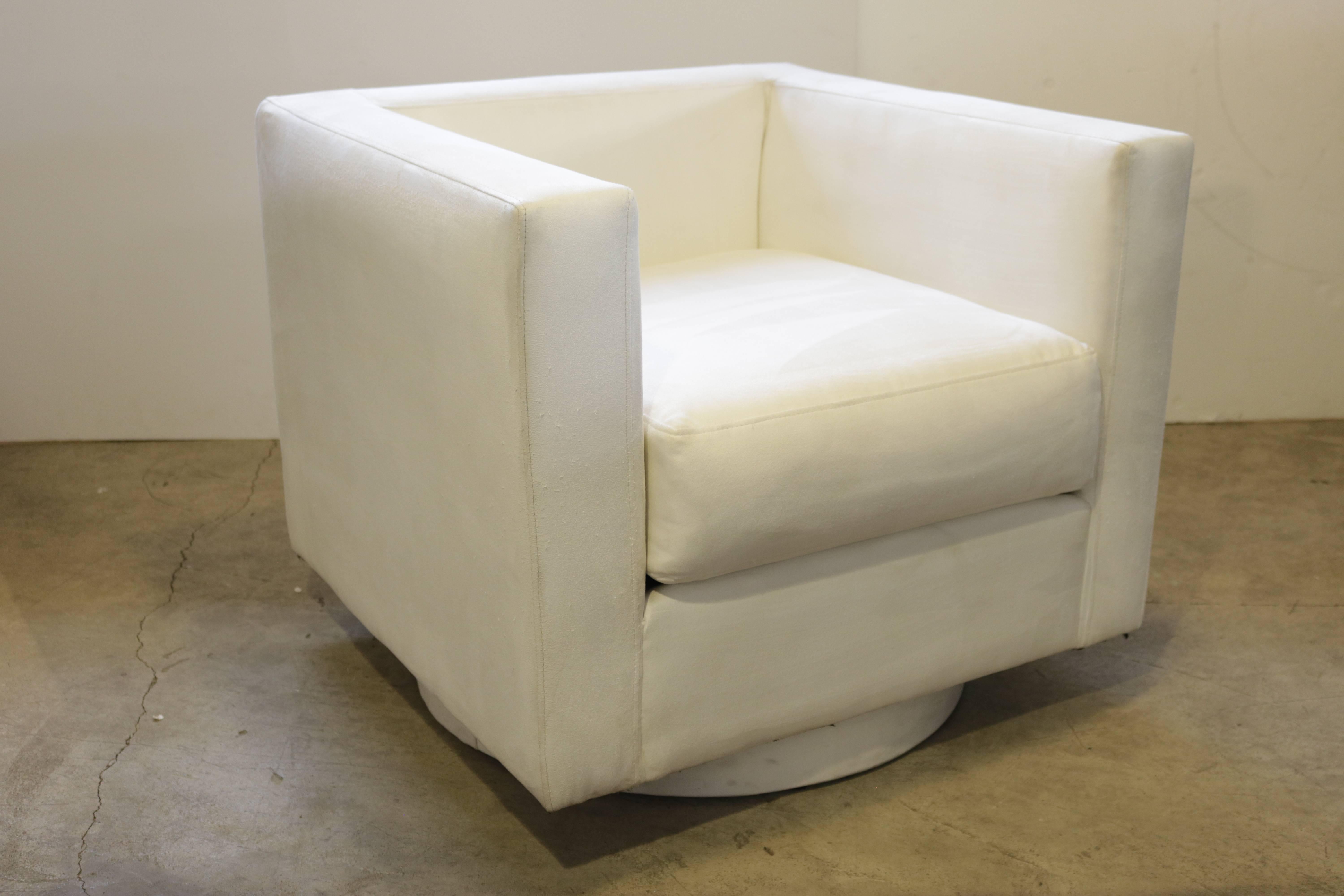 Upholstered, tuxedo style chair on a swivel base. Tuxedo arms are a sleek, streamlined style where the arms are the same height as the back of the chair. Seat depth is 25.0". We suggest that the buyer have the chair recovered because the back