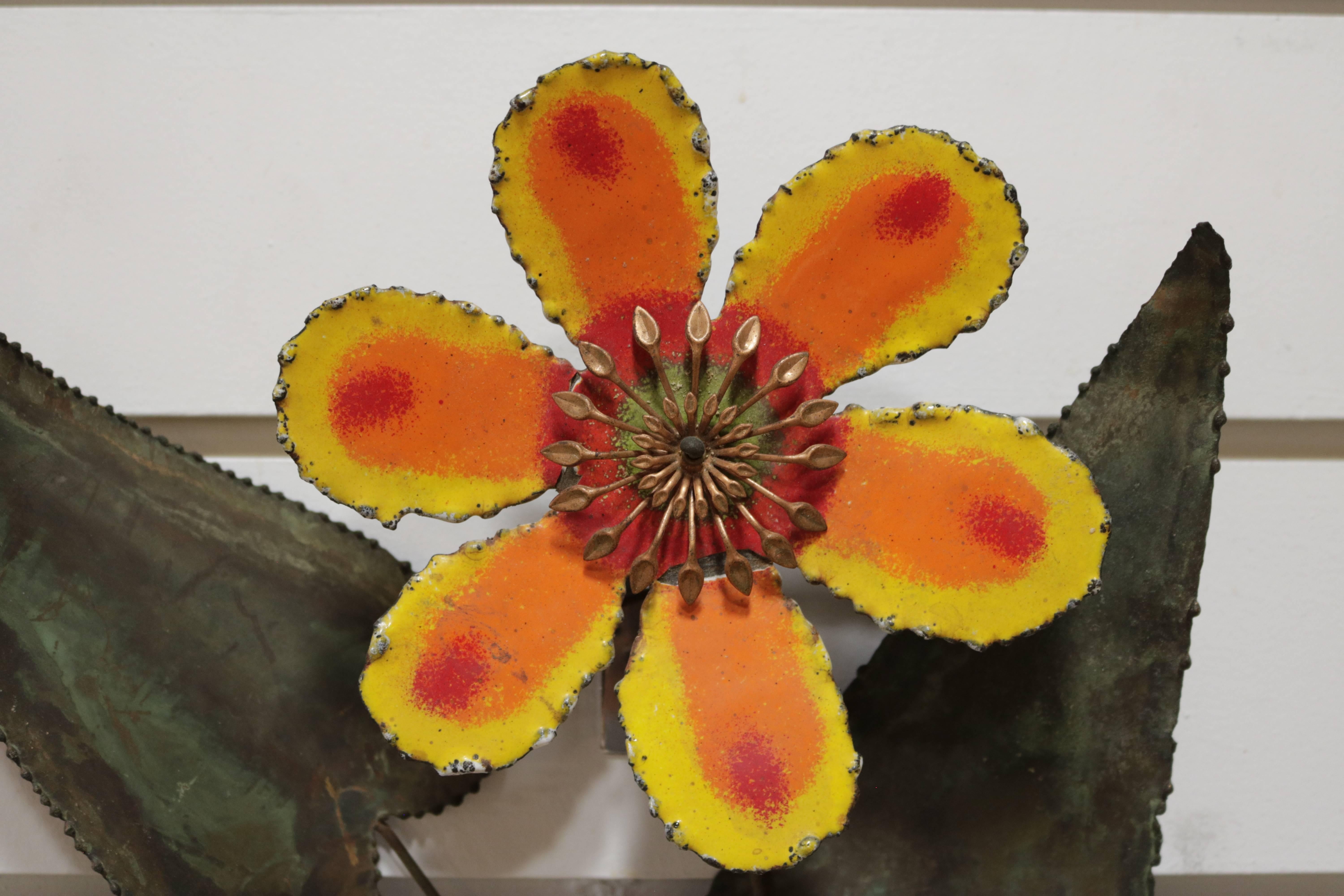 The flower is enameled in orange and yellow and the leaves are patinated in green.
It is signed C. Jere and dated 1967.
This is a perfect gift.