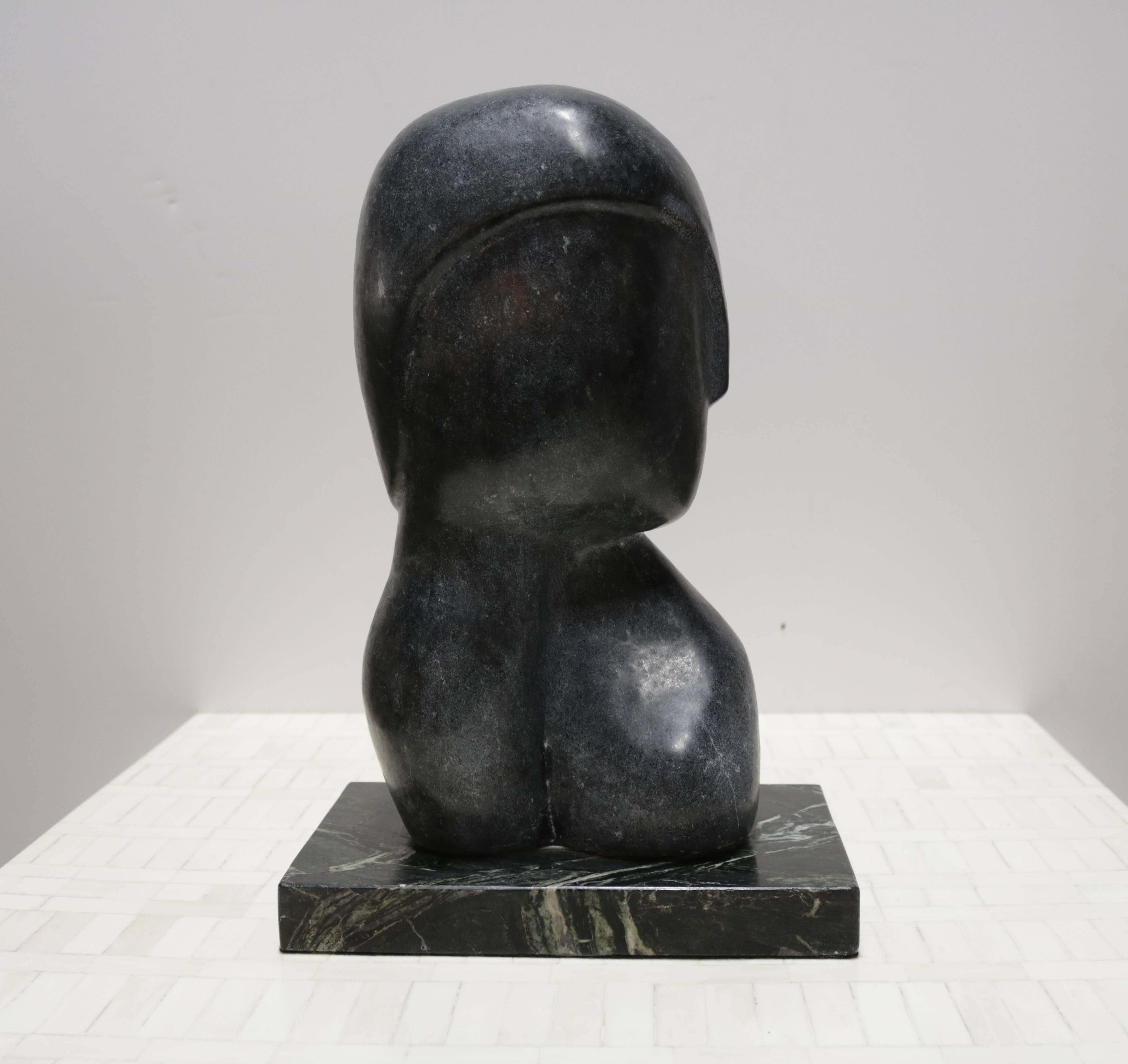 Strong black marble figurative sculpture on marble base. Signed on one side "Yospin '90".