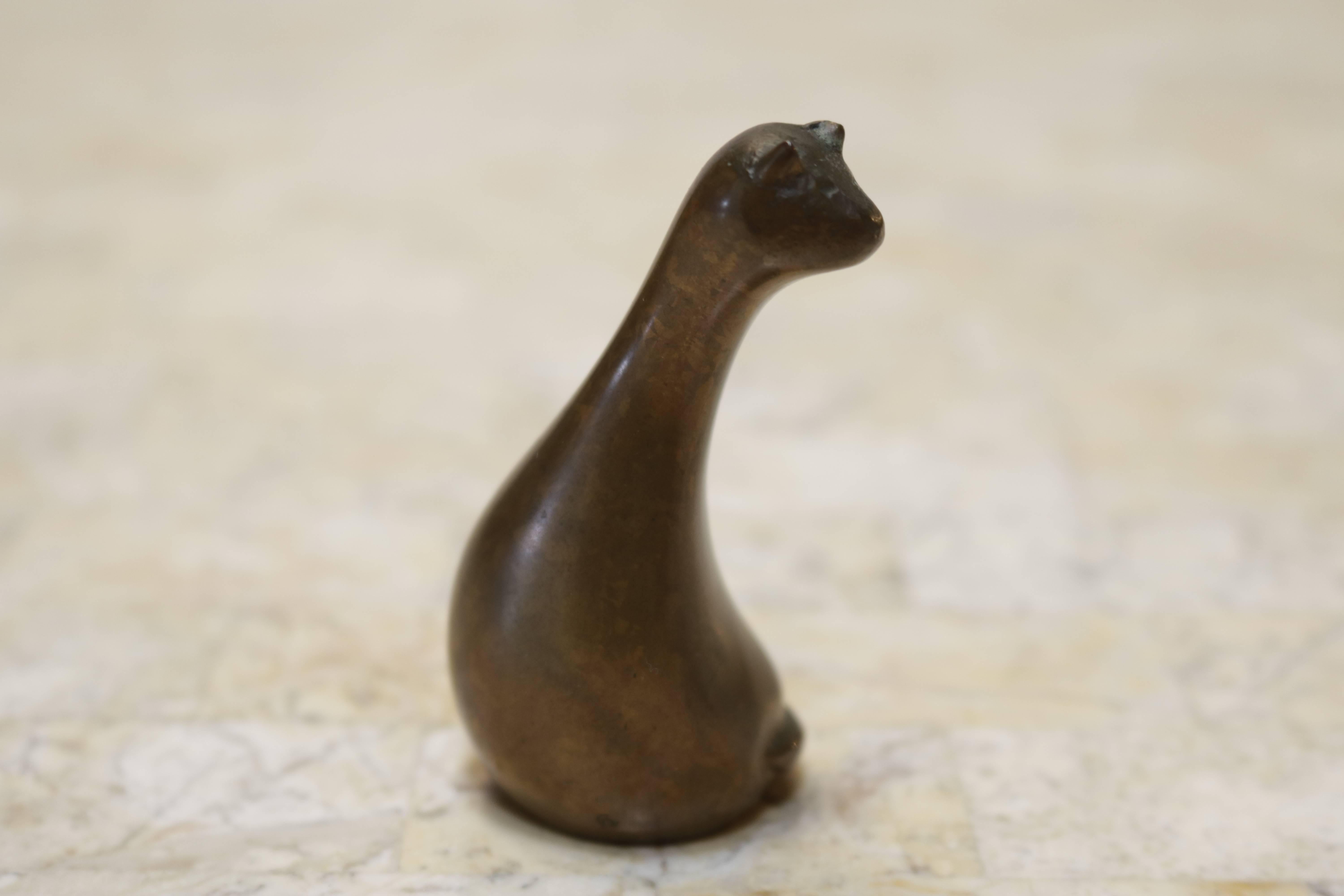 Little sculpture of a cat which could make a charming paperweight. The bronze has a beautiful patina and make you feel like holding it in your hands. 
It is signed with two letters on the bottom.
