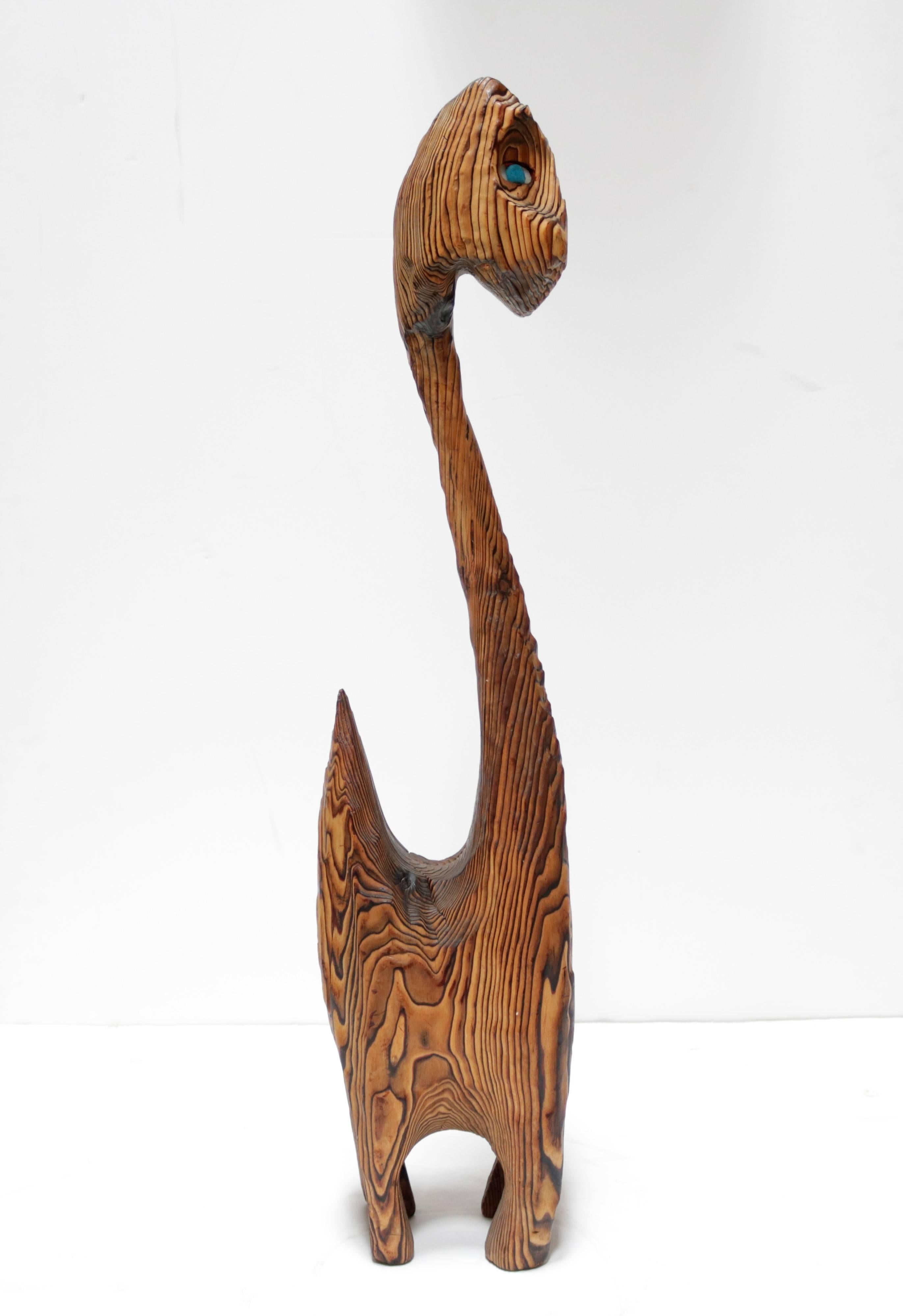 Sculpture of a standing cat in exotic Bocote wood. Notice the beautiful use of the wood's grain and how it runs along the lines of the piece. The wood grain is dimensional, meaning you can feel all of the ridges and it has not been polished smooth.