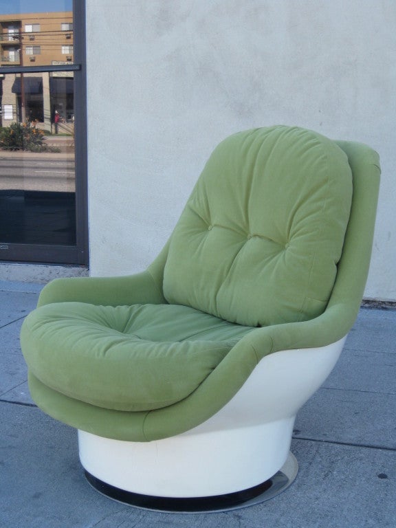 Super cozy fiberglass chair upholstered in a soft almond colored suede. Seat is at a reclined angle for extra comfort and support. Chair swivels and sits on chrome base.