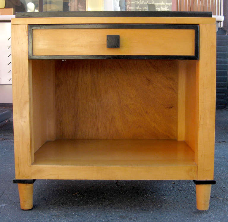 This functional side table, end table, or nightstand features a single cavity and a pull-out drawer that is marked 
