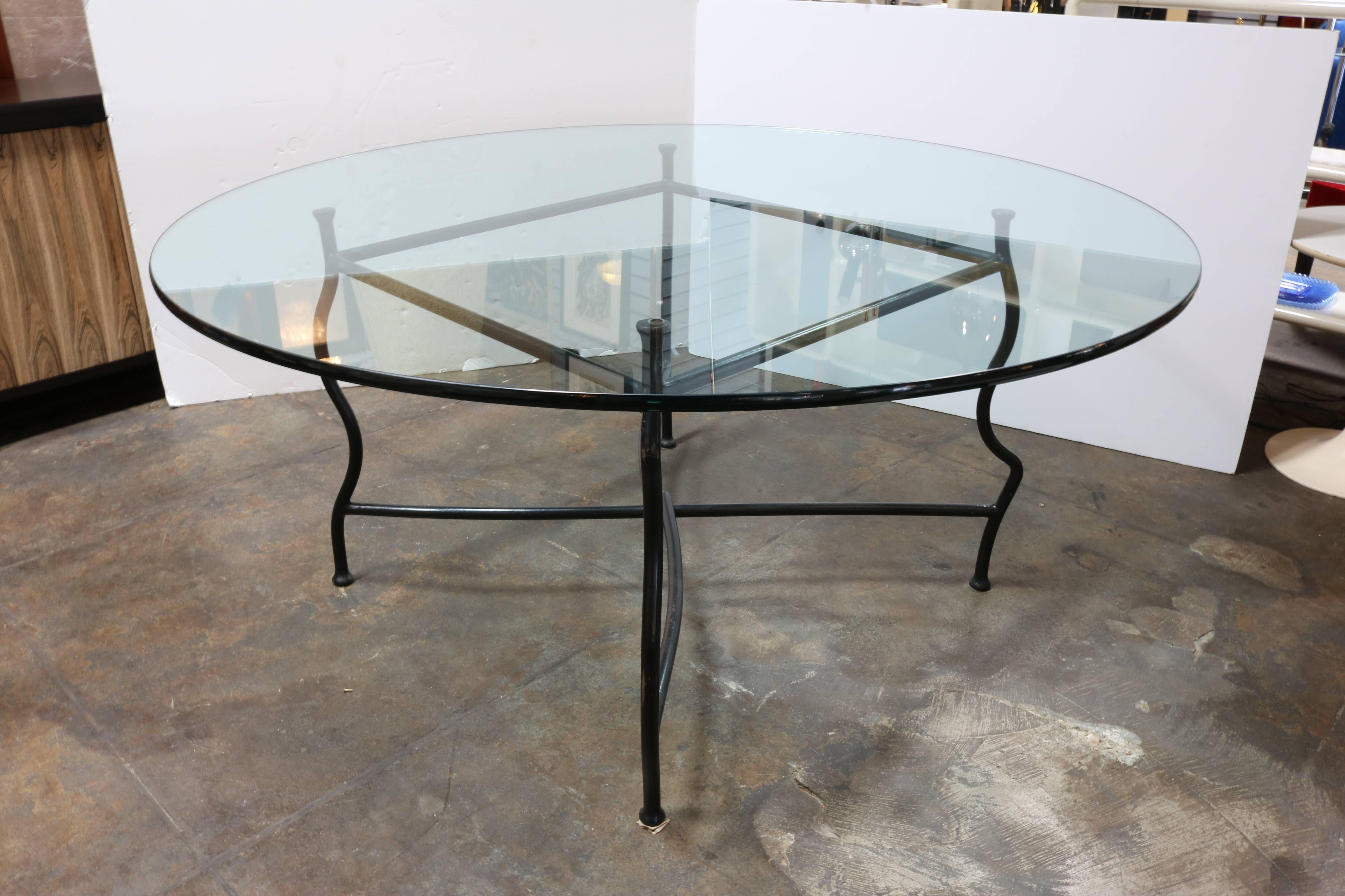 The frame of this unusual dining table was crafted in steel with a gun finish.
Undulating legs alternate in a convex and concave formation.
However, despite this hint of whimsy, the table is incredibly sturdy and solid.
The legs are united by a