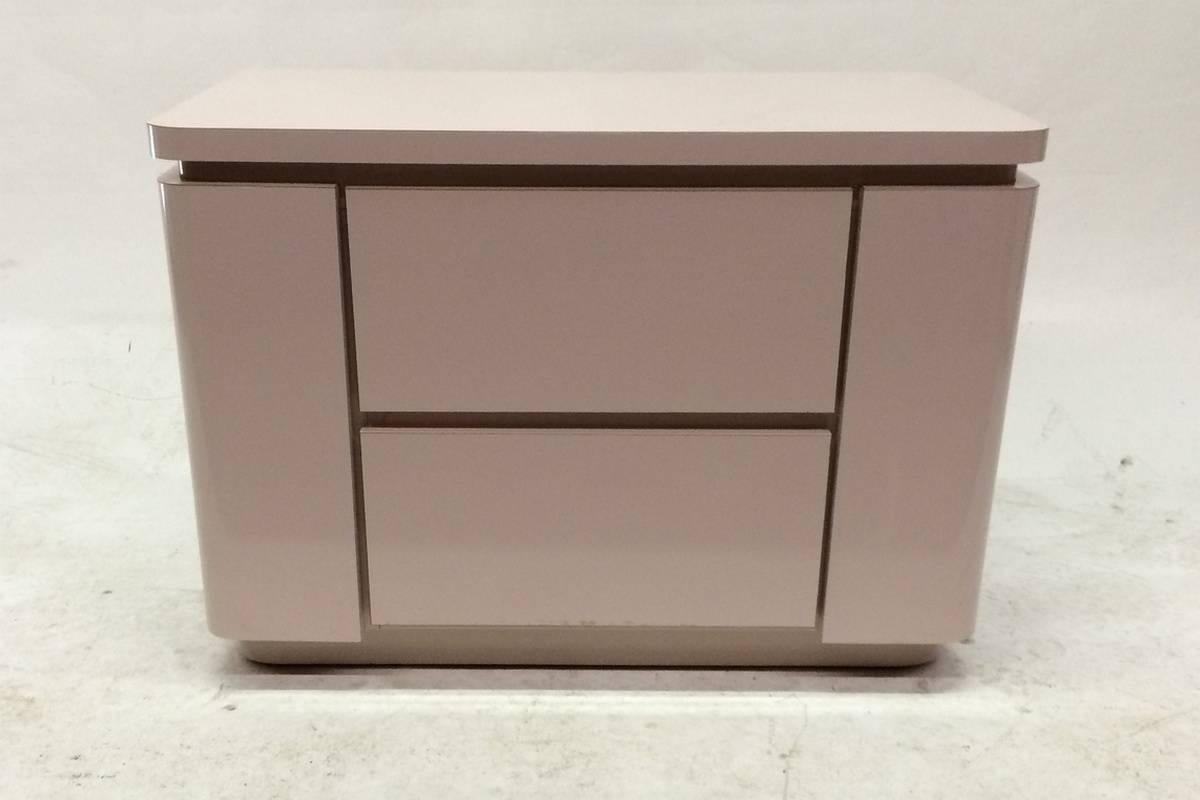 Laminate is a pale, dusty pink and corners of each piece are rounded. Glamorous, but, not at all fragile, as both pieces are sturdy and well-made. Would look great in a young girl's bedroom. Nice and low in height.