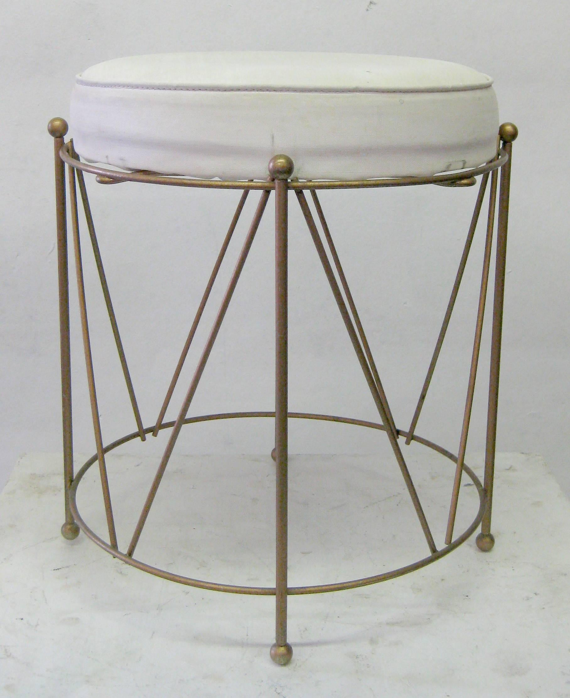 Playful round stool with geometric brass base and white vinyl cushion. The bent brass base is finished with eight balls on top and bottom giving it a regal finished feel.