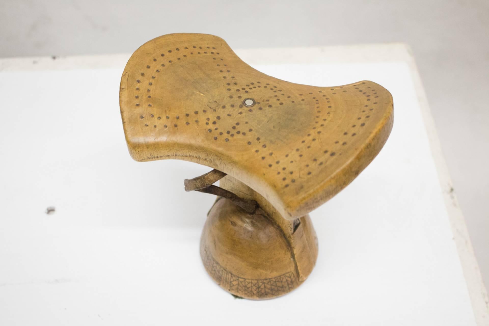 An authentic African headrest from Ethiopia. These traditional pieces with incised decorative lines and rich patina are from the Sidamo people in Ethiopia. 
The headrests were usually carved from a single piece of fine-grained wood.