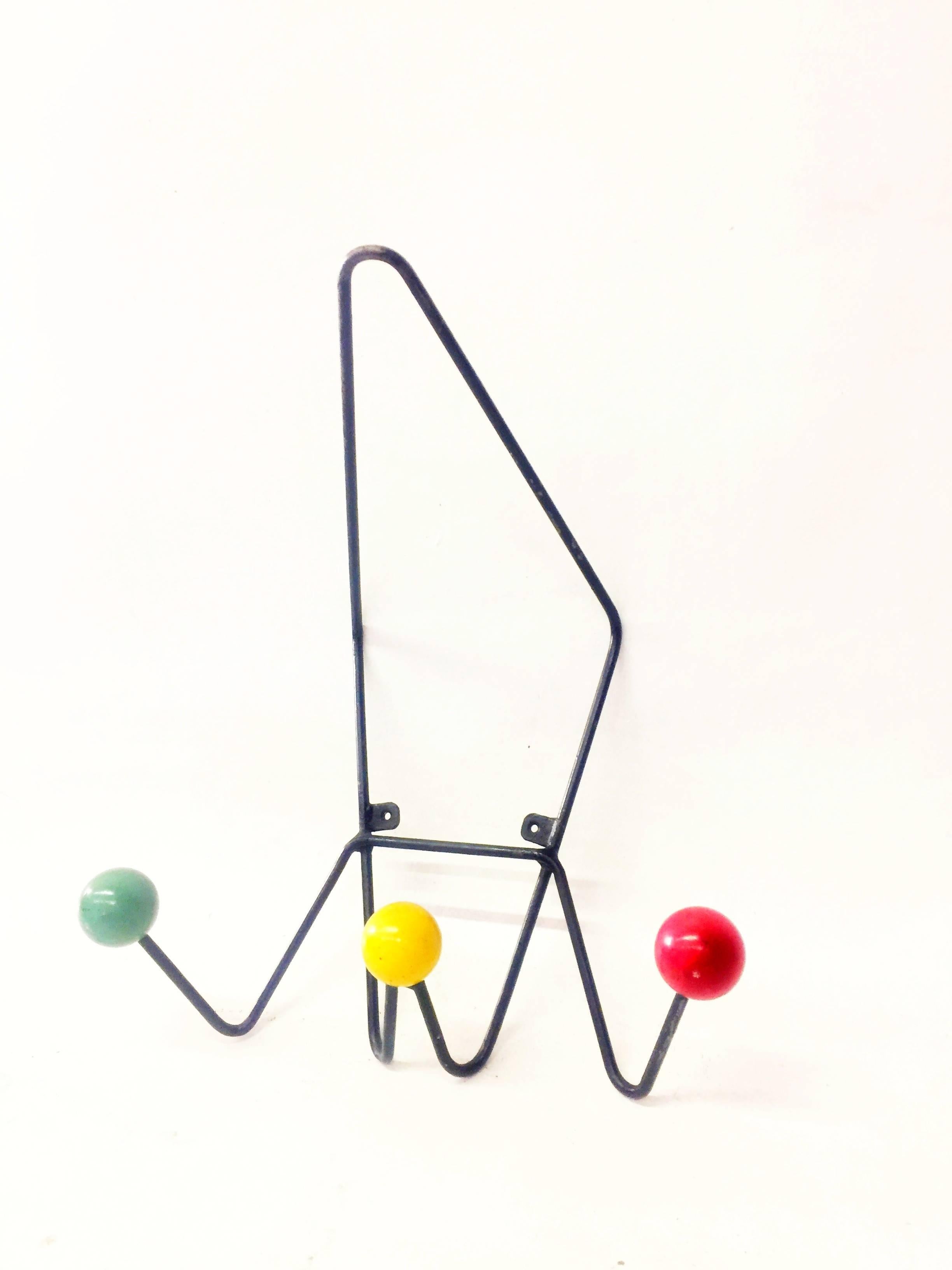 Wall-mounted metal coat hook with three colorful balls on the end of each section. Each ball measures approximately 2 inches in diameter. Please see our separate listing for the matching standing coat rack.