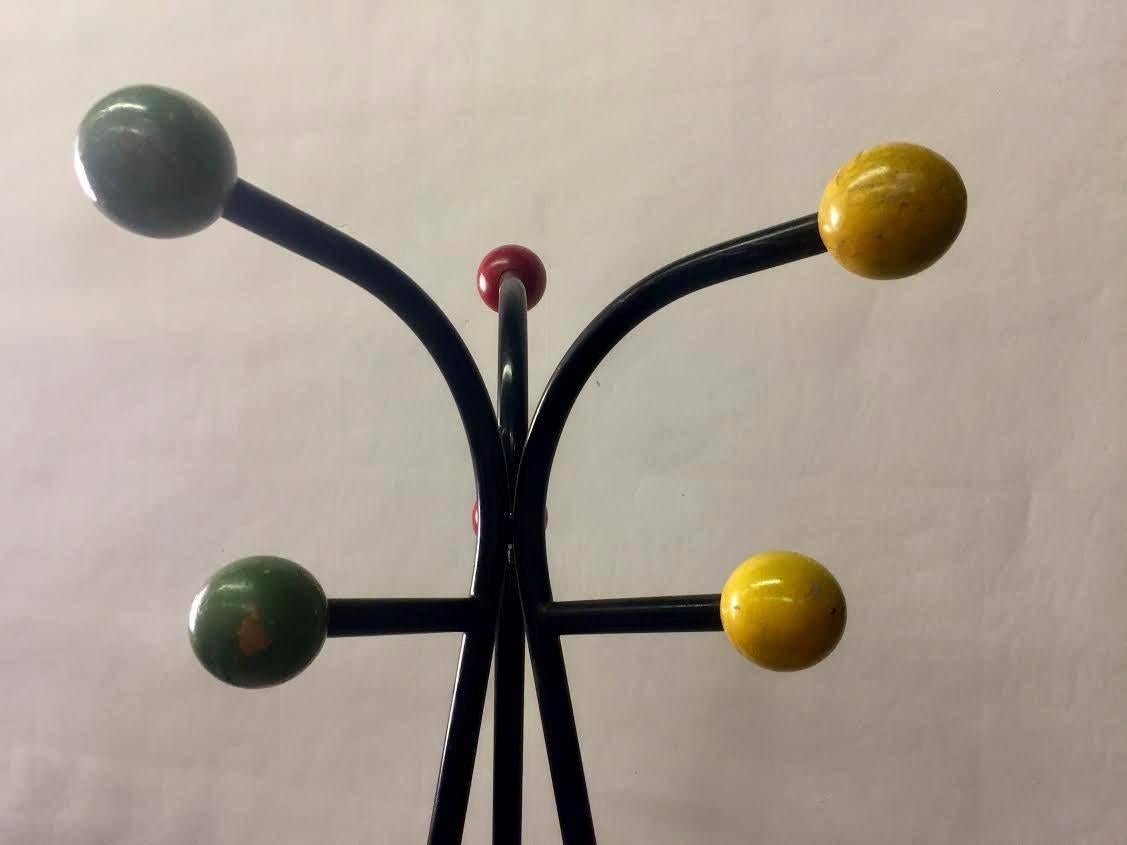 Black metal standing coat rack with colorful ball end pieces. Each ball measures approximately 2.50 inches in diameter. Please see our separate listing for a matching hanging wall-mounted rack.