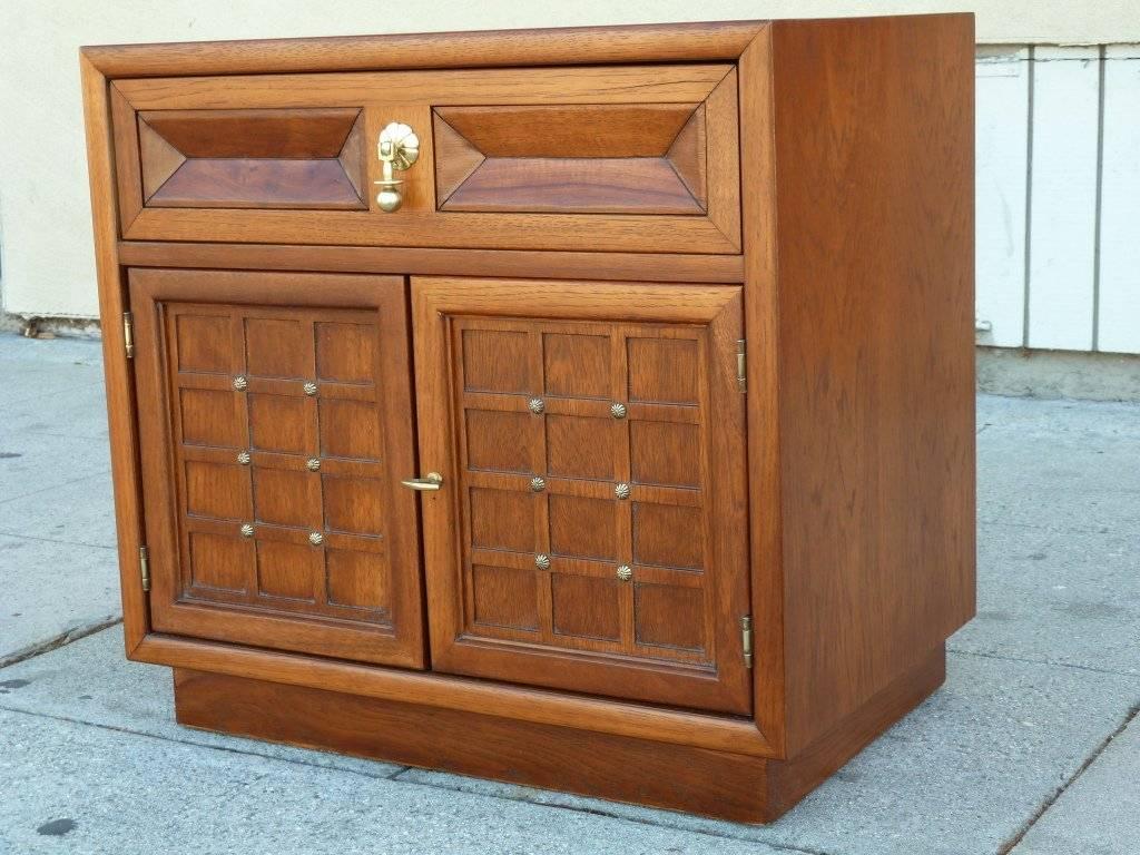 These nightstands made of walnut with brass hardware and decoration feature a drawer and two doors. They are extremely well crafted like all furniture by American of Martinsville.
