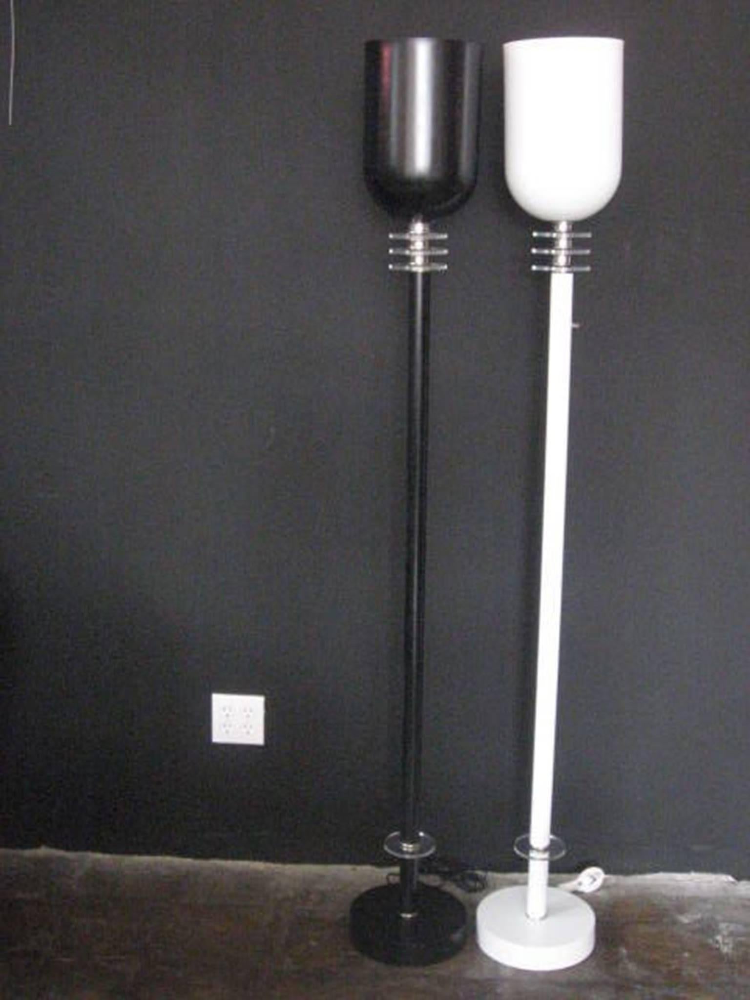 These matching black and white floor lamps have three Lucite rings with chrome finish at the top and one at the bottom. With slender shafts, the shades are formed in a cylinder shape.