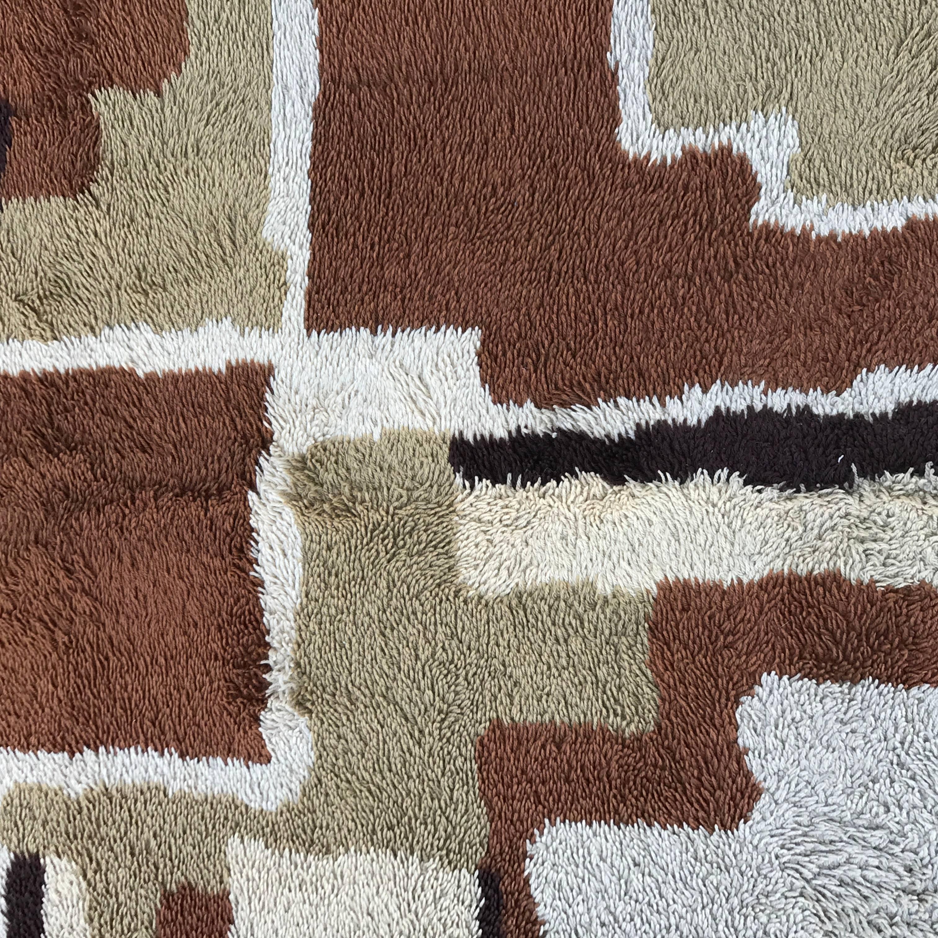 This Swedish shag rug is in shades of brown, beige and cream and has 1/2 inch fibers. Rug will be cleaned before being sent to buyer.