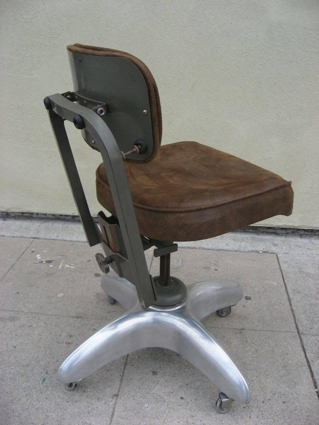 Cast aluminium base swivel chair. The back and seat are adjustable. It has new upholstery in brown ultrasuede. Wheels were missing. So the four have been changed.
