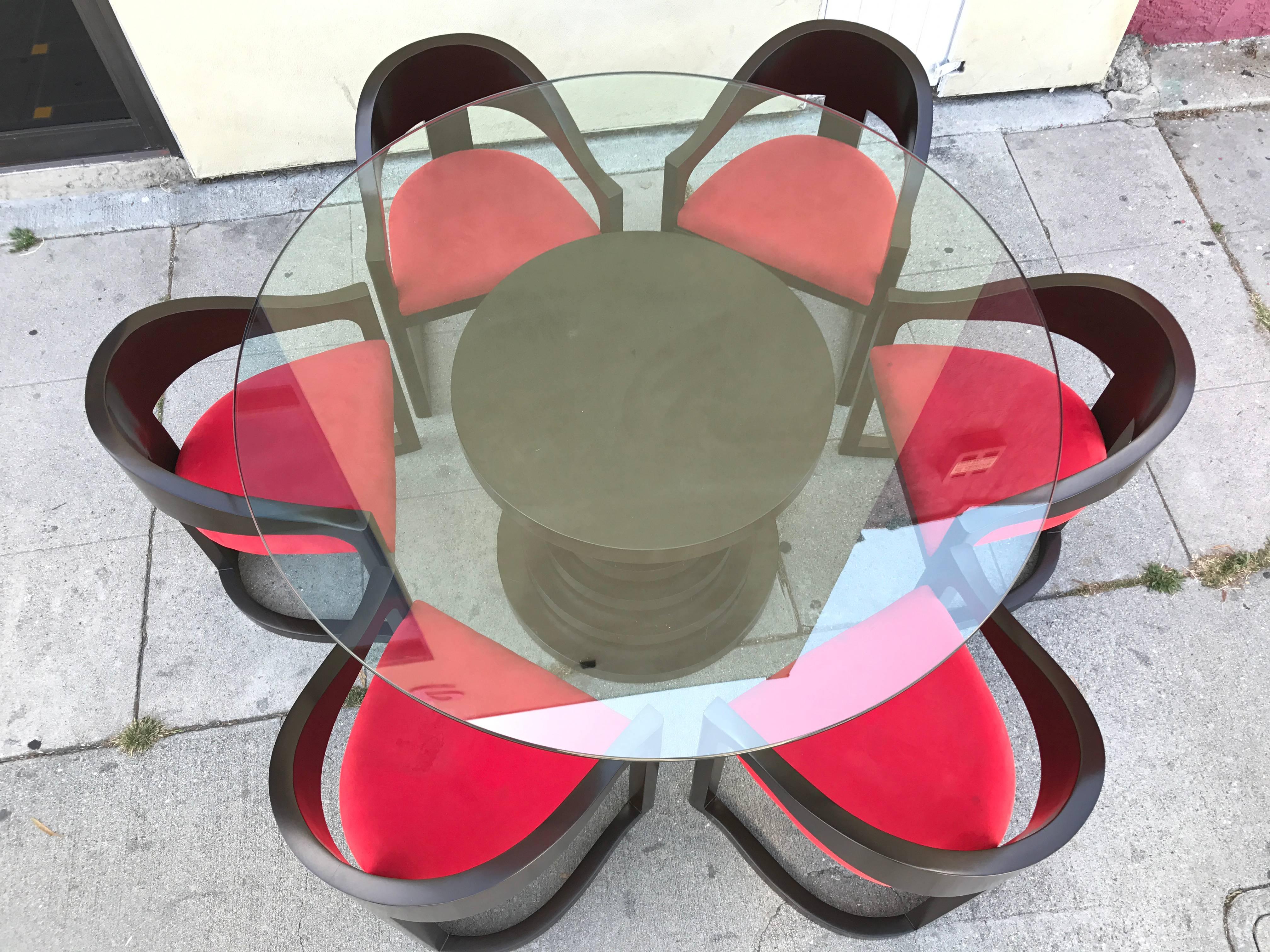 Stunning dining set in the style of Karl Springer features a round base with graduating tiers which alternate the espresso brown and red lacquer. Includes matching set of six dining chairs. See our other listings for a matching pair of counter