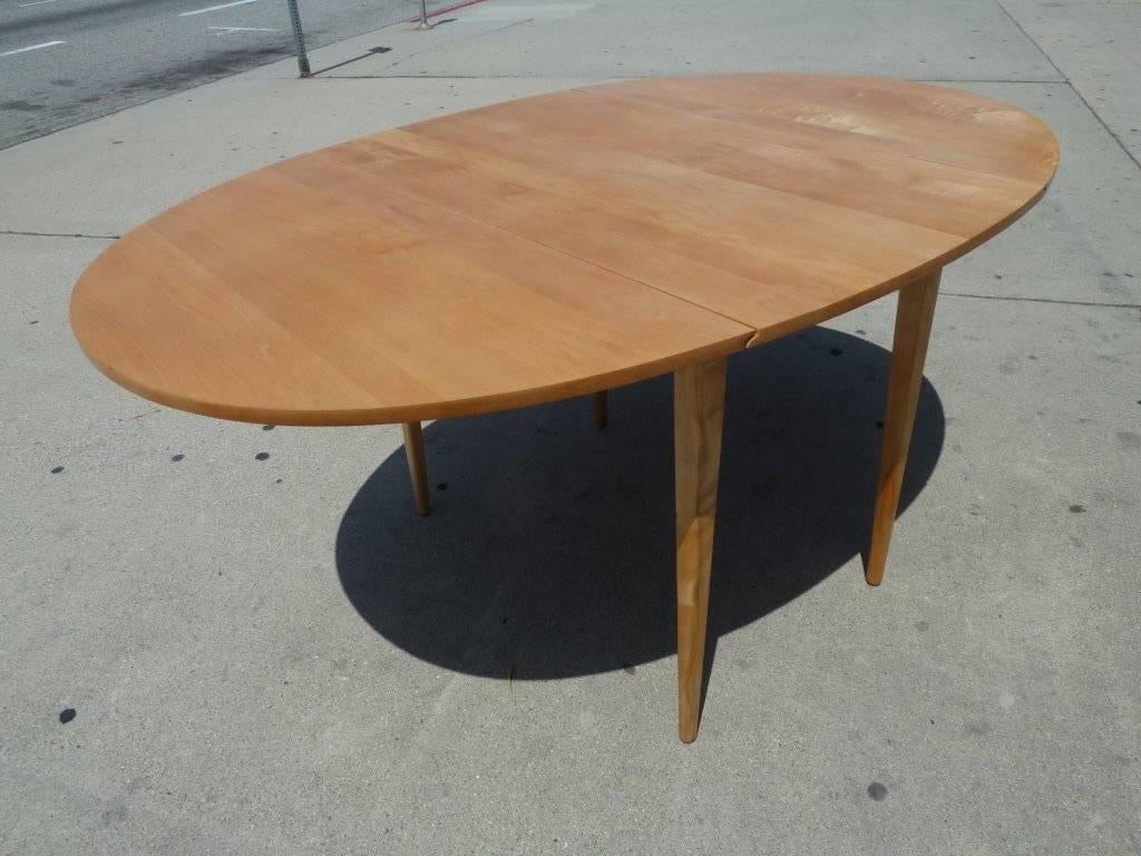 This oval dining table designed by Paul McCobb is made of solid maple for Planner Group, Winchendon Furmiture Company.
When the table is open the length is 59 1/2.
