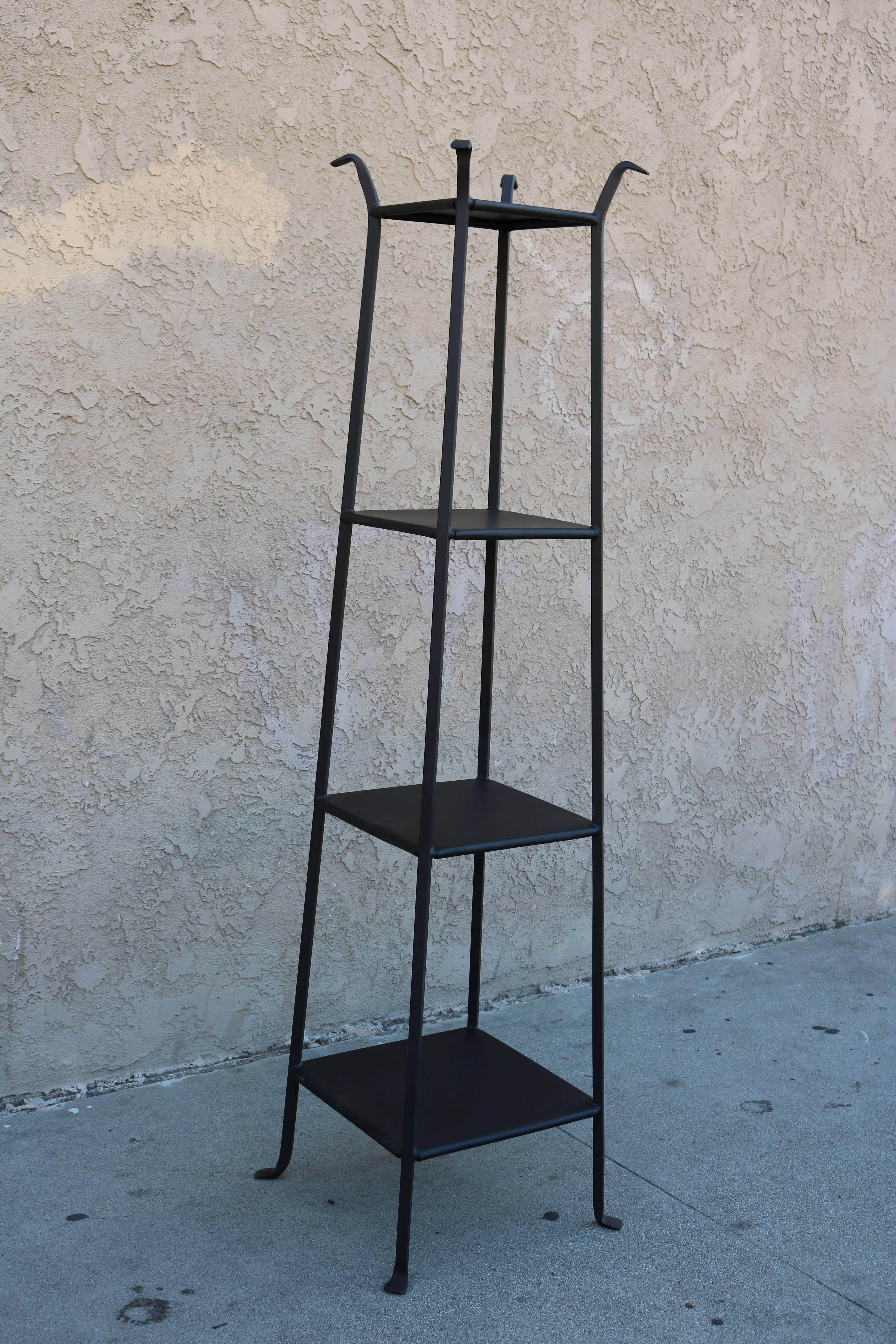 Black metal etagere or open shelving unit. Total height of piece is 67.5