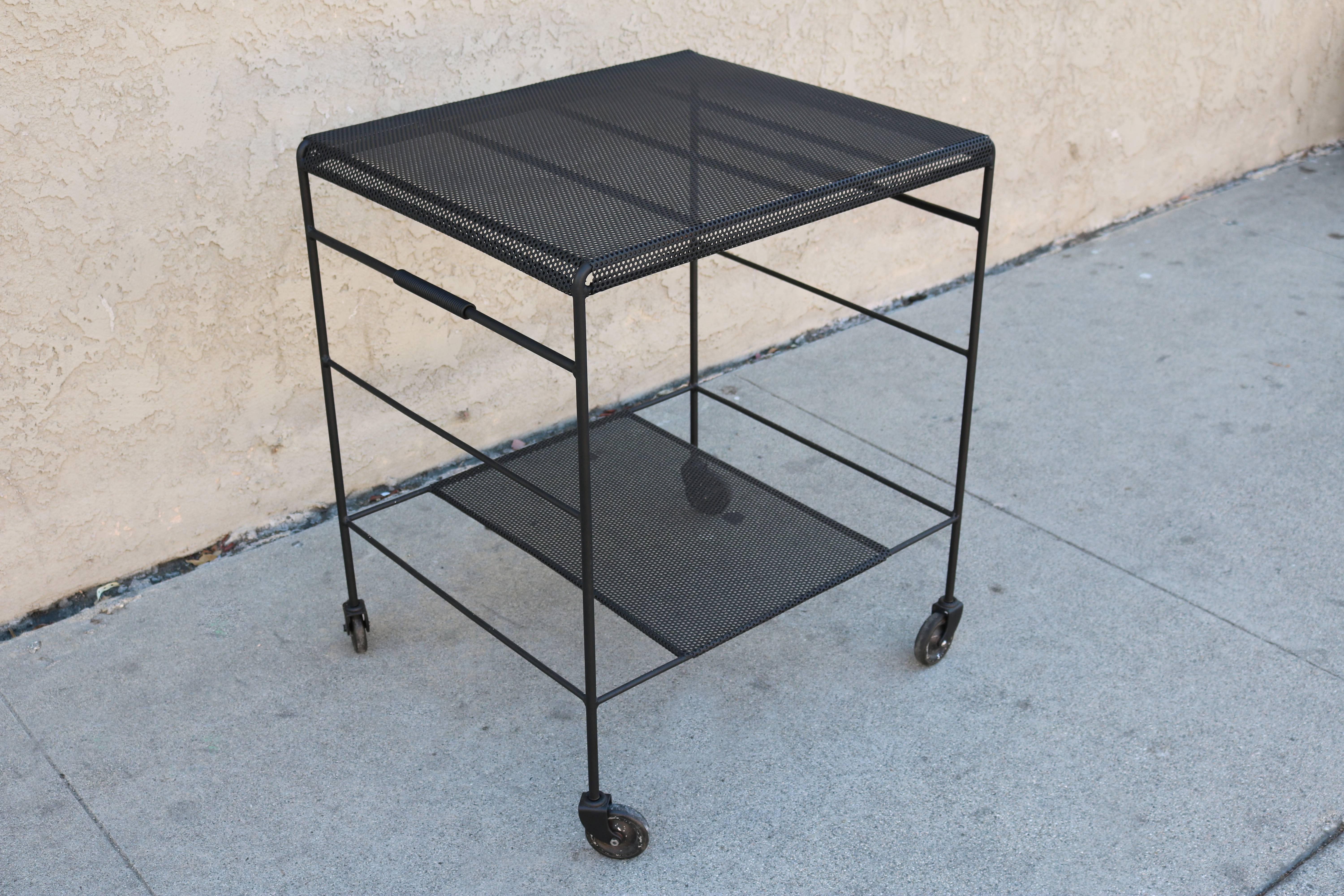 Mathieu Matégot bar cart in perforated metal on wheels. Newly refinished in matte black powder coating. We may have another similar piece - please contact Galerie Sommerlath for more information.
 