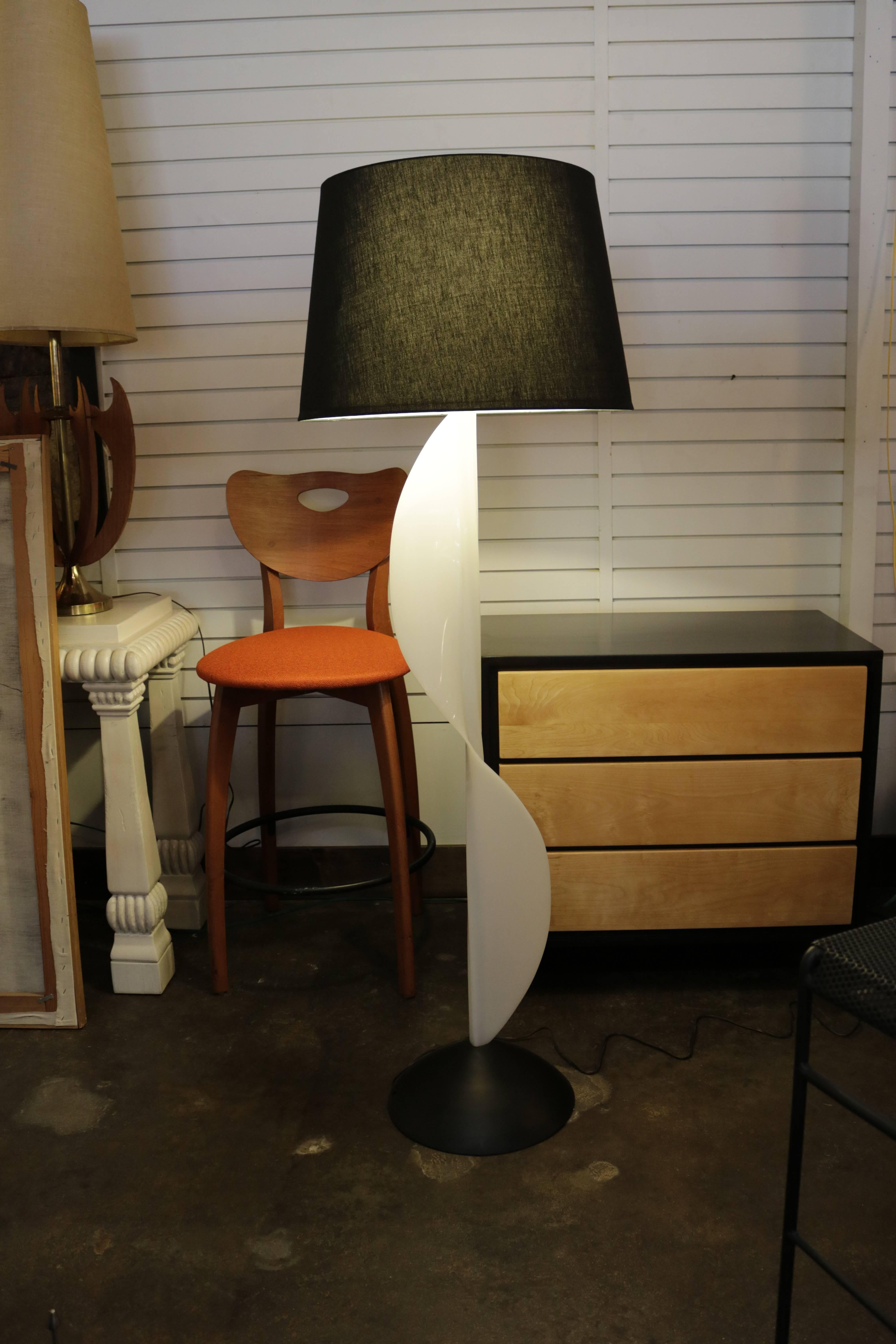 Molded resin floor lamp made in Canada by Rougier. Lamp has an unique undulating, wave-like design. Measures 13" in diameter across the base, 62" H to top of finial or 50" H to bottom of harp.
