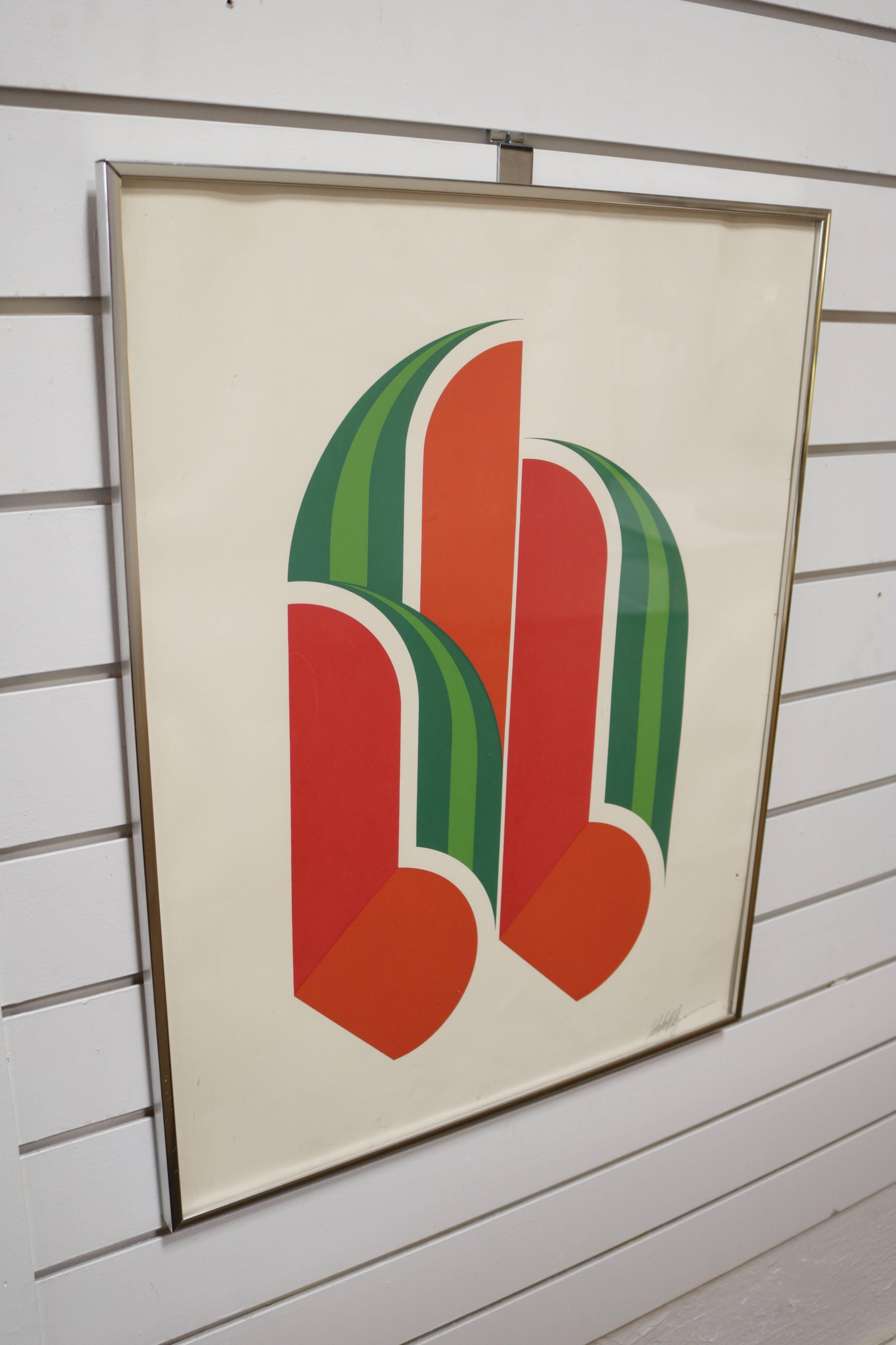 Framed lithograph print of a bisected watermelon done in a graphic Futurist style and sitting in achrome frame. Signed by the artist, however signature is illegible.