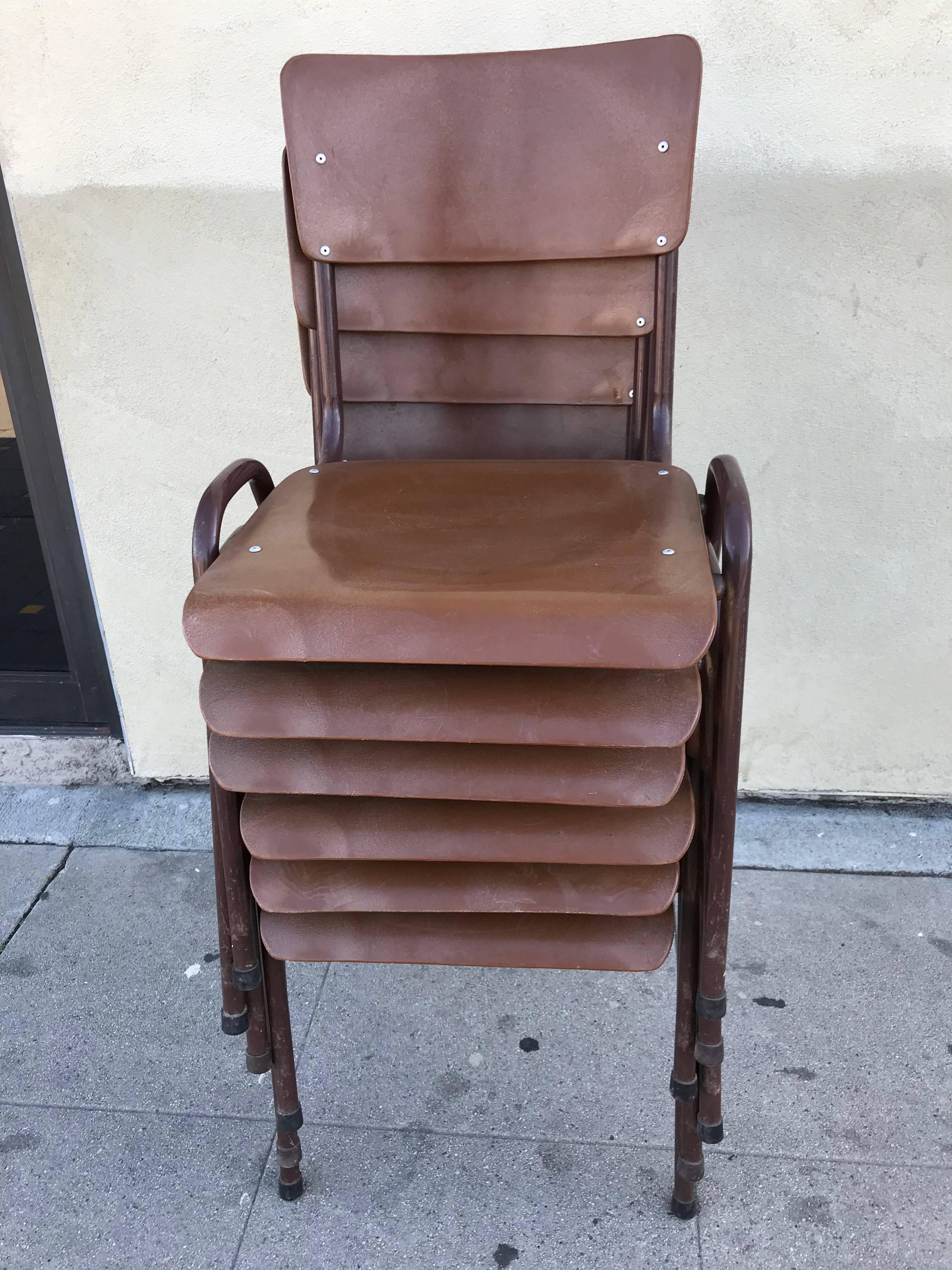 Set of six stackable school chairs in brown lacquer metal and strong brown plastic.
