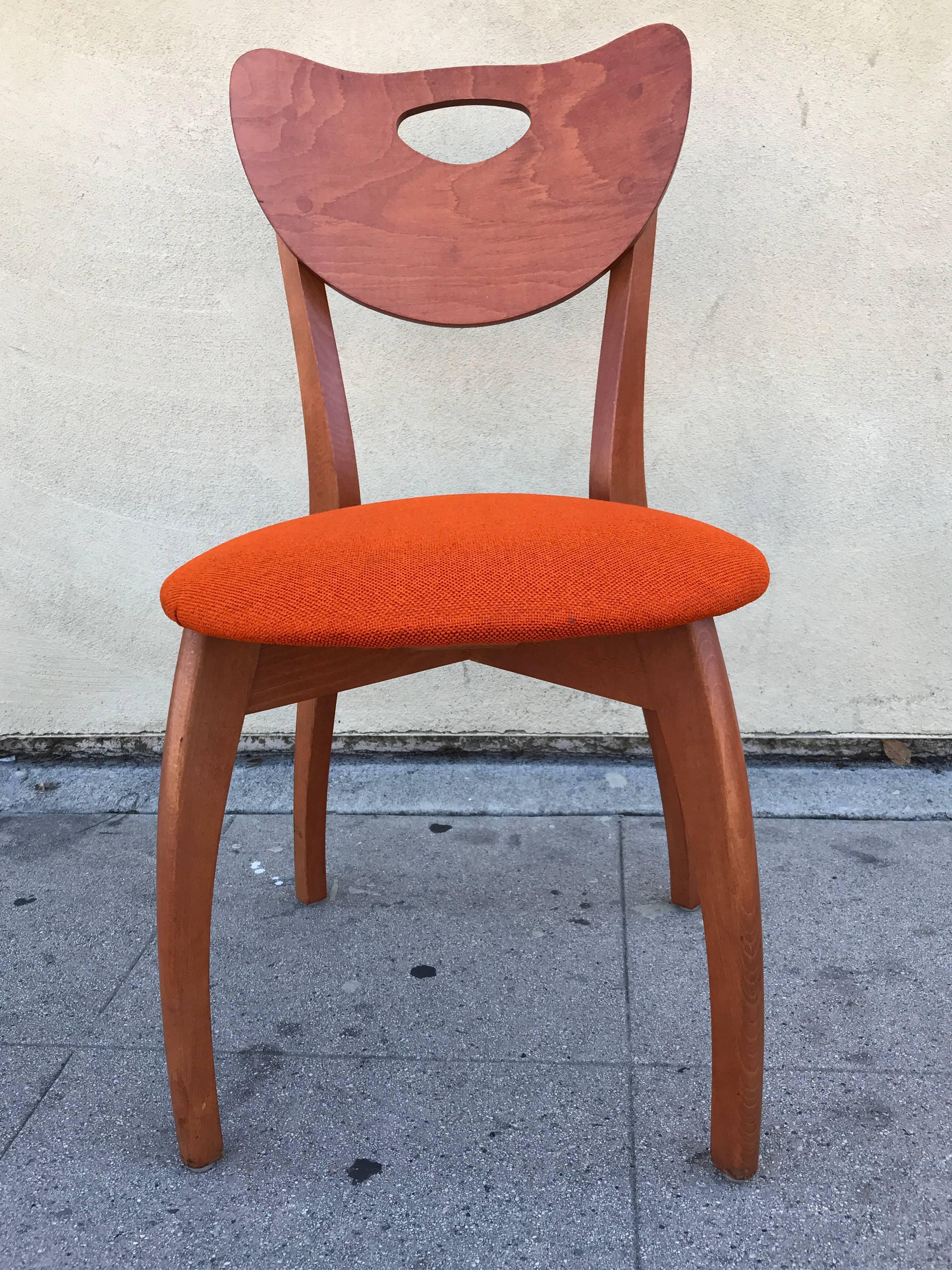 Set of four Danish modern chairs in teak with their original burnt orange colored upholstery
 

 