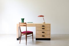 An elegant 1940s desk covered in parchment