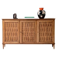 1950's cabinet with woven ribbon patterns front door