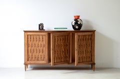1950's cabinet with woven ribbon patterns front door