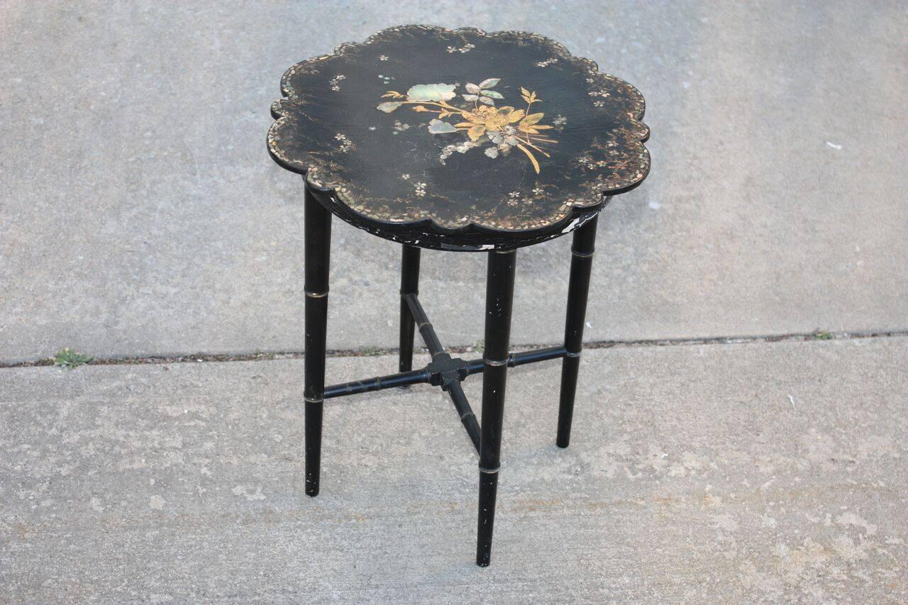 Lightweight chinoiserie side table or small stool. Painted bamboo support system, syncopating scalloped edge on surface. Legs narrow towards the bottom. Inlay and gilt painted floral and foliage designs. Excellent patina, wear and condition.