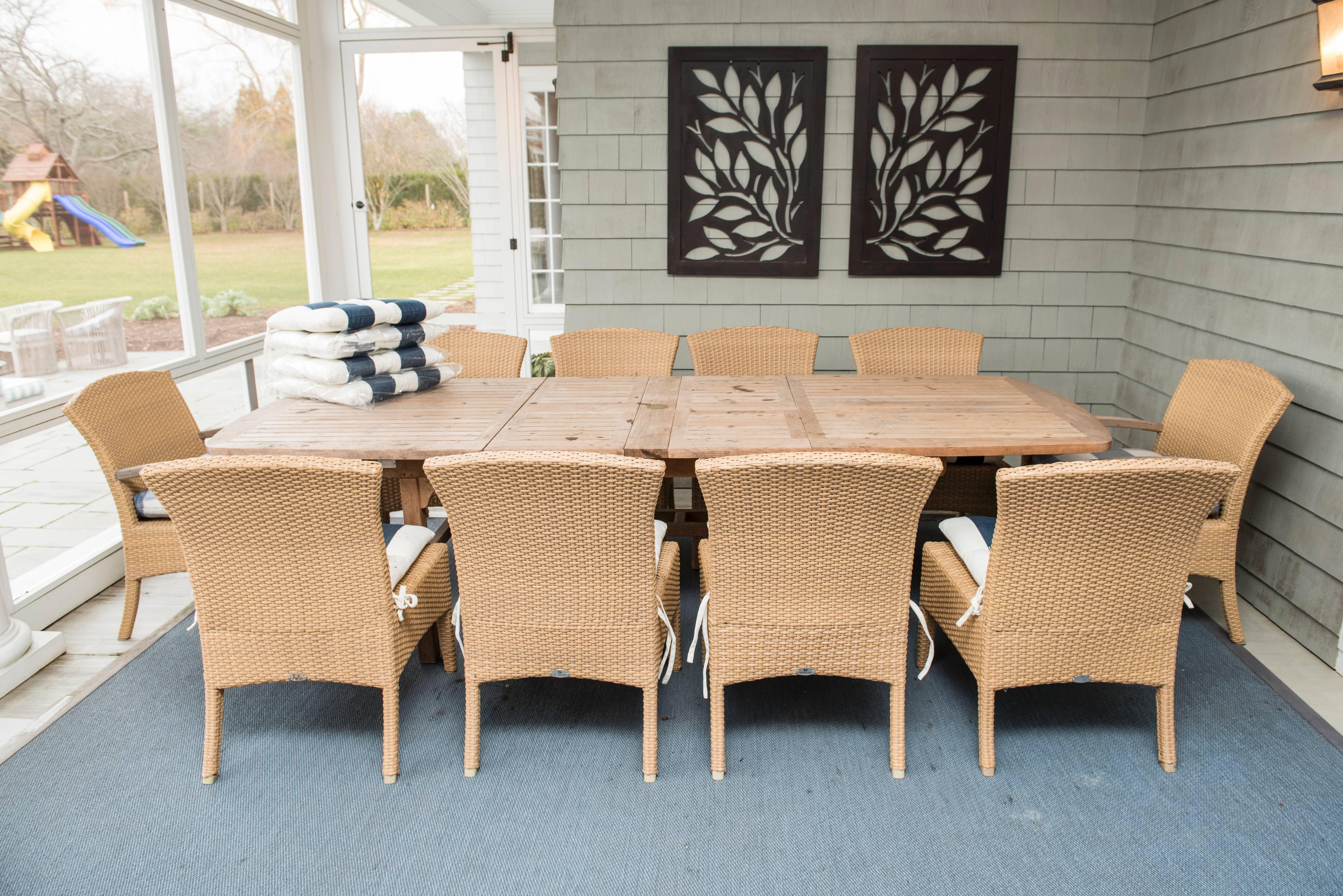 Teak dining table with ten chairs included.