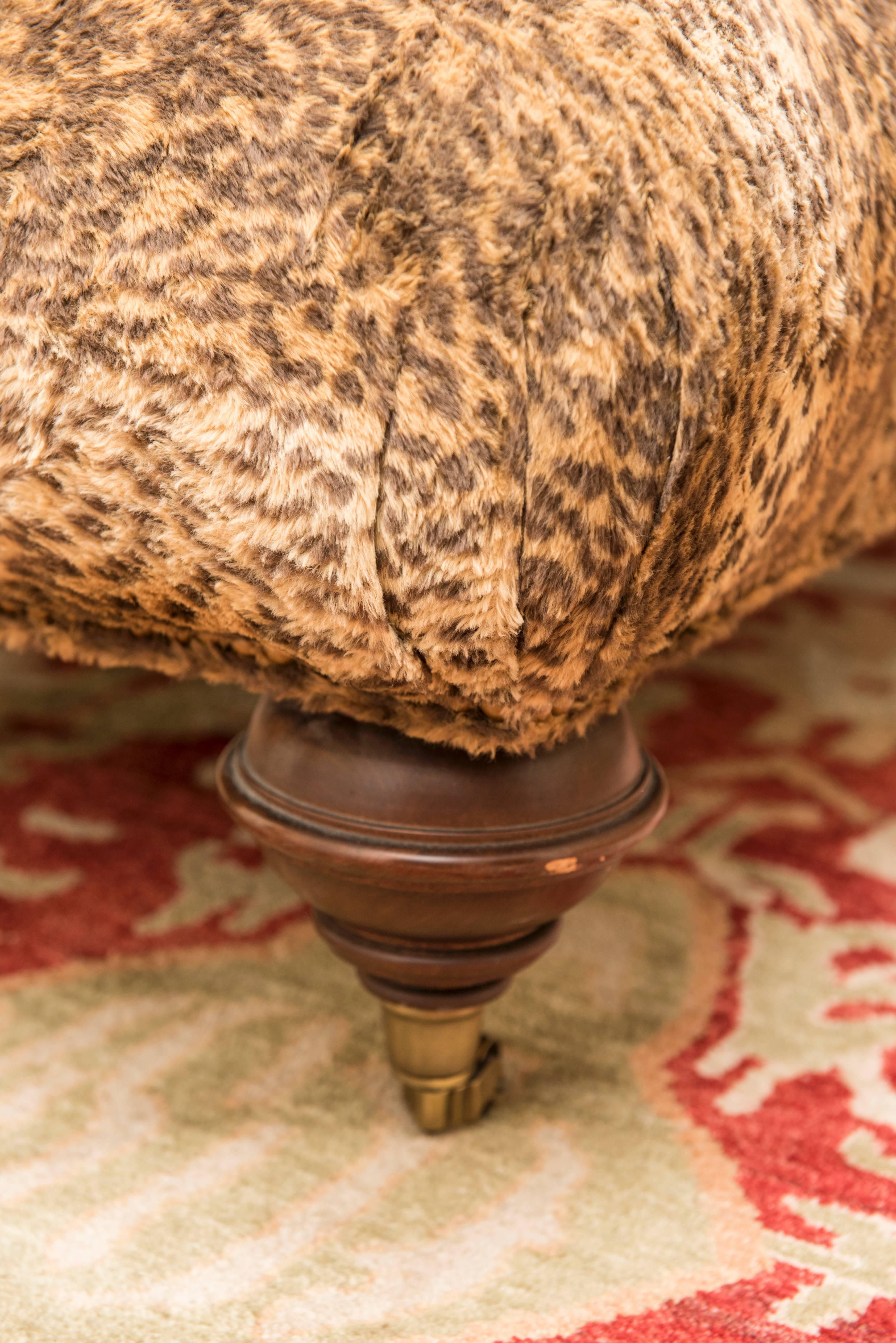 Cheetah print ottoman. Very classical and very comfortable.