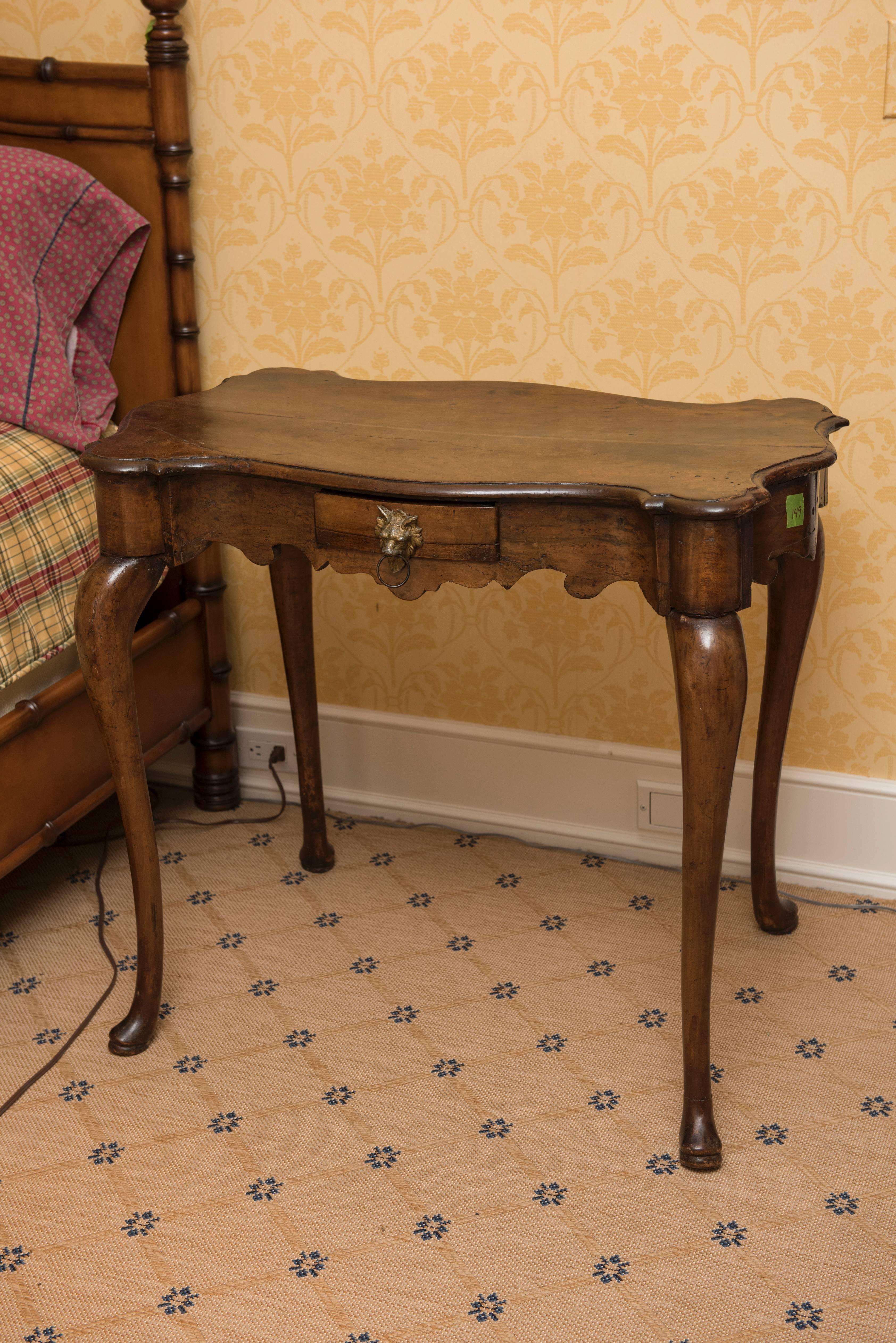 Walnut side table. Beautiful carved detail.