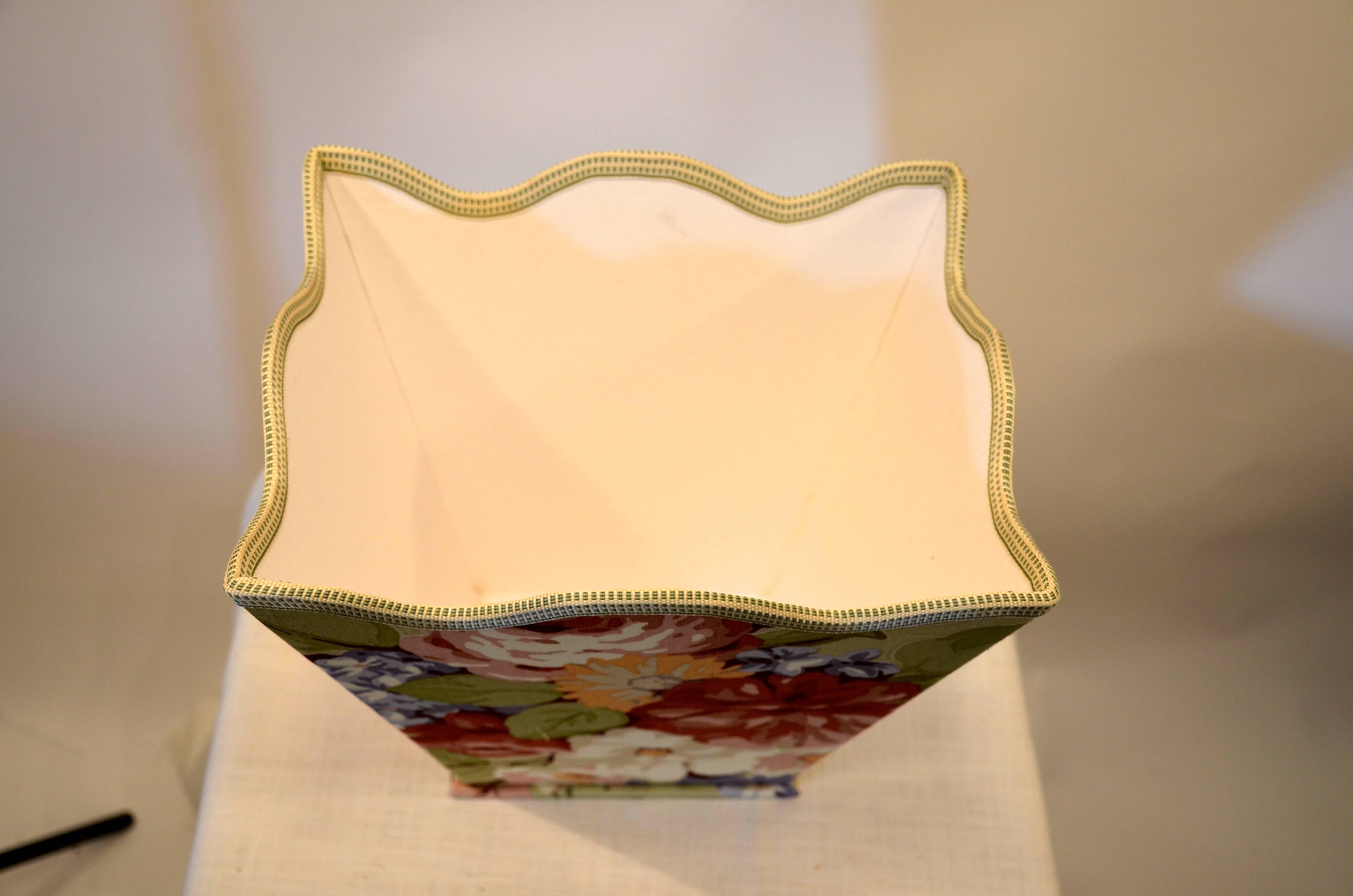 Handmade floral wastebasket with scalloped edge.