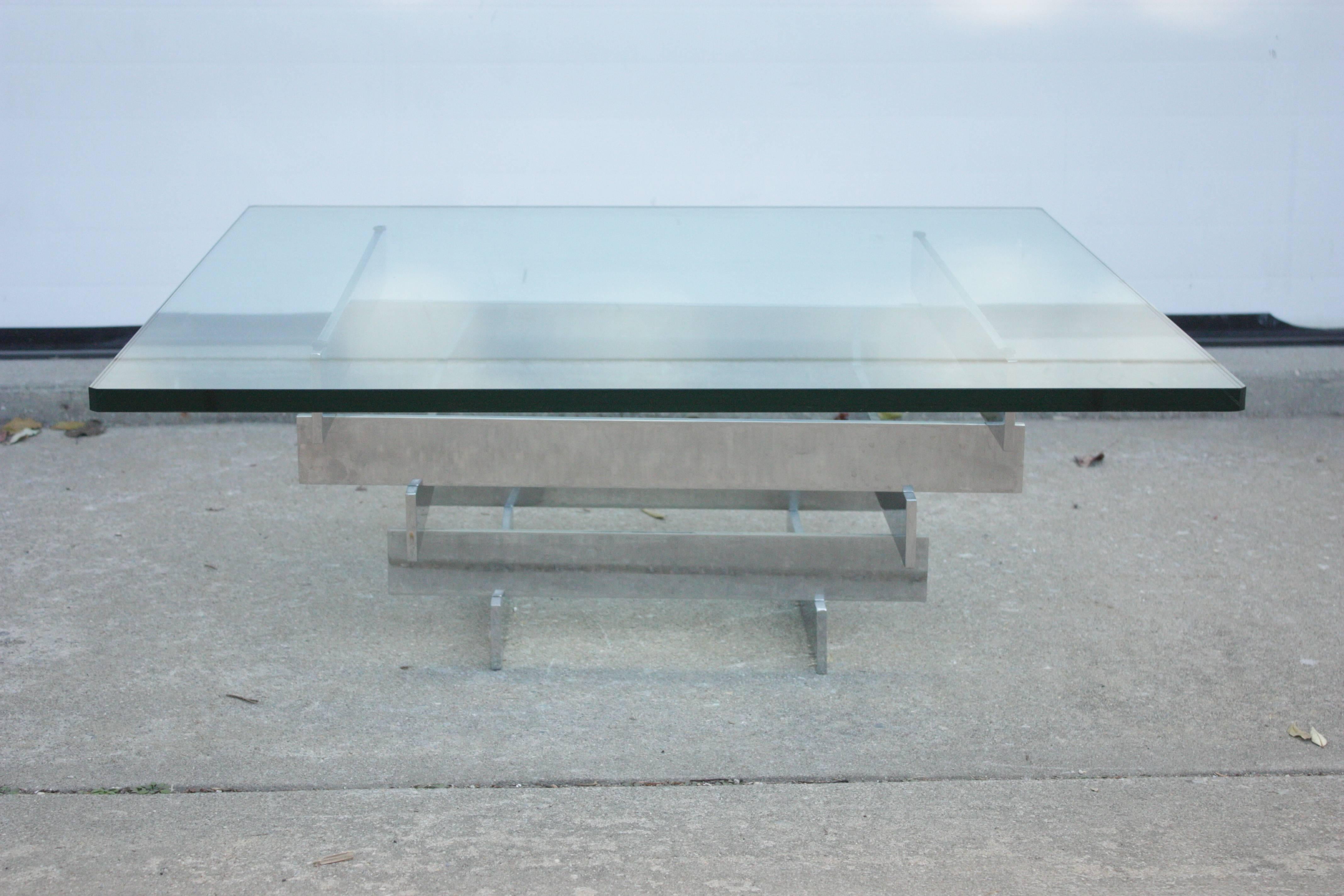 1970s midcentury chrome and glass stacked geometric beam coffee table.
Heavy, thick clear square glass top with fillet corners. Optical as well as dimensional presence.