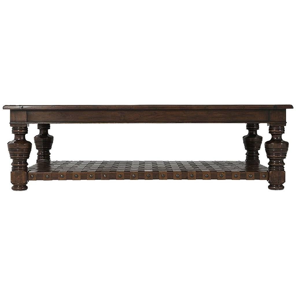 Beautiful antique coffee table, with woven leather as bottom shelf.