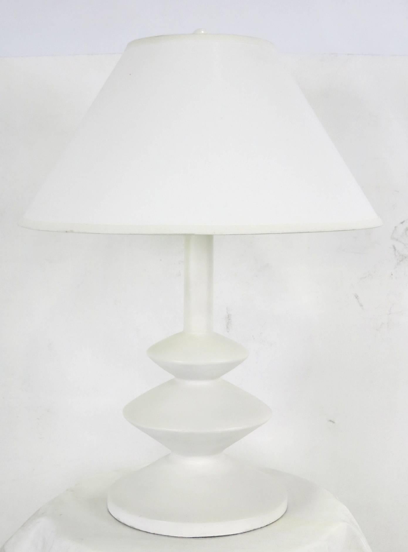 Beautiful pair of finished plaster table lamps after those by Giacometti for Jean-Michel Frank.  The lamps feature double clusters and round white-painted ball finials.  Finest quality materials and workmanship.  