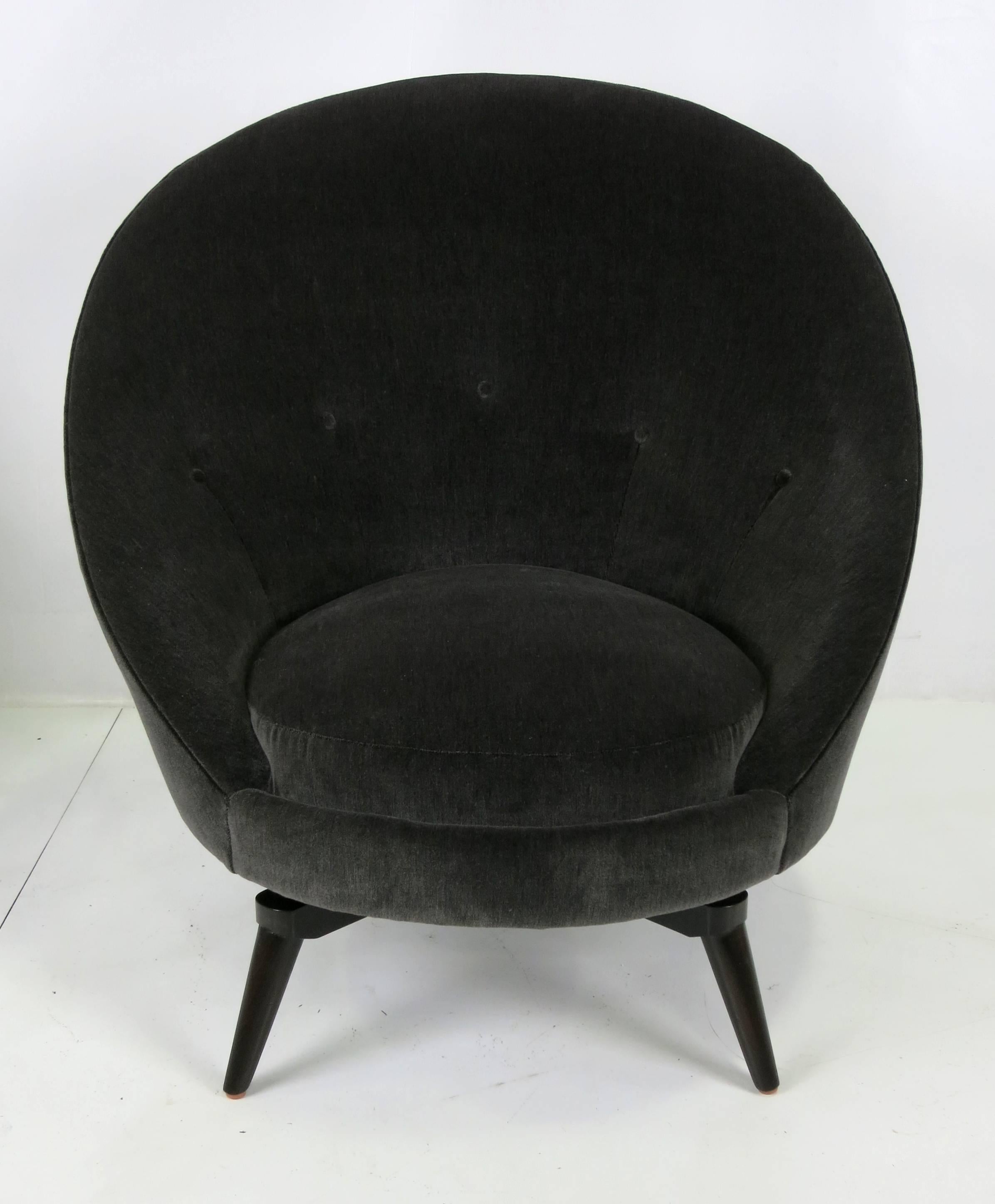 Pair of swivel egg chairs in the style of Jean Royere. The swivel bases have been reconstructed from the originals and are stouter and more durable, finished in dark brown lacquer. Com upholstery available upon request at an extra charge.