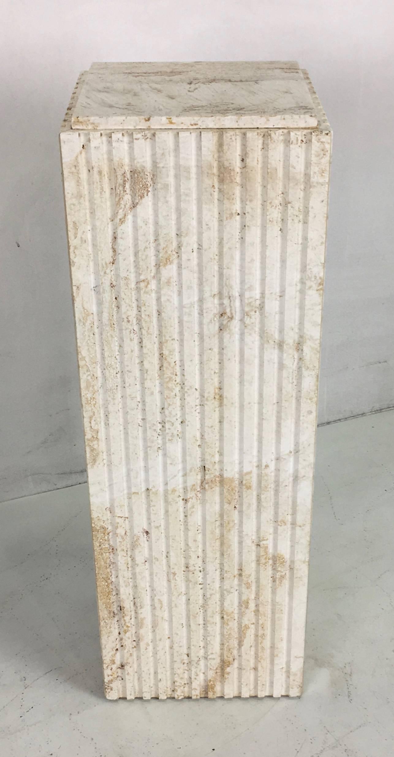 Beautifully rendered Italian made pedestal of unfilled travertine with fluted sides.