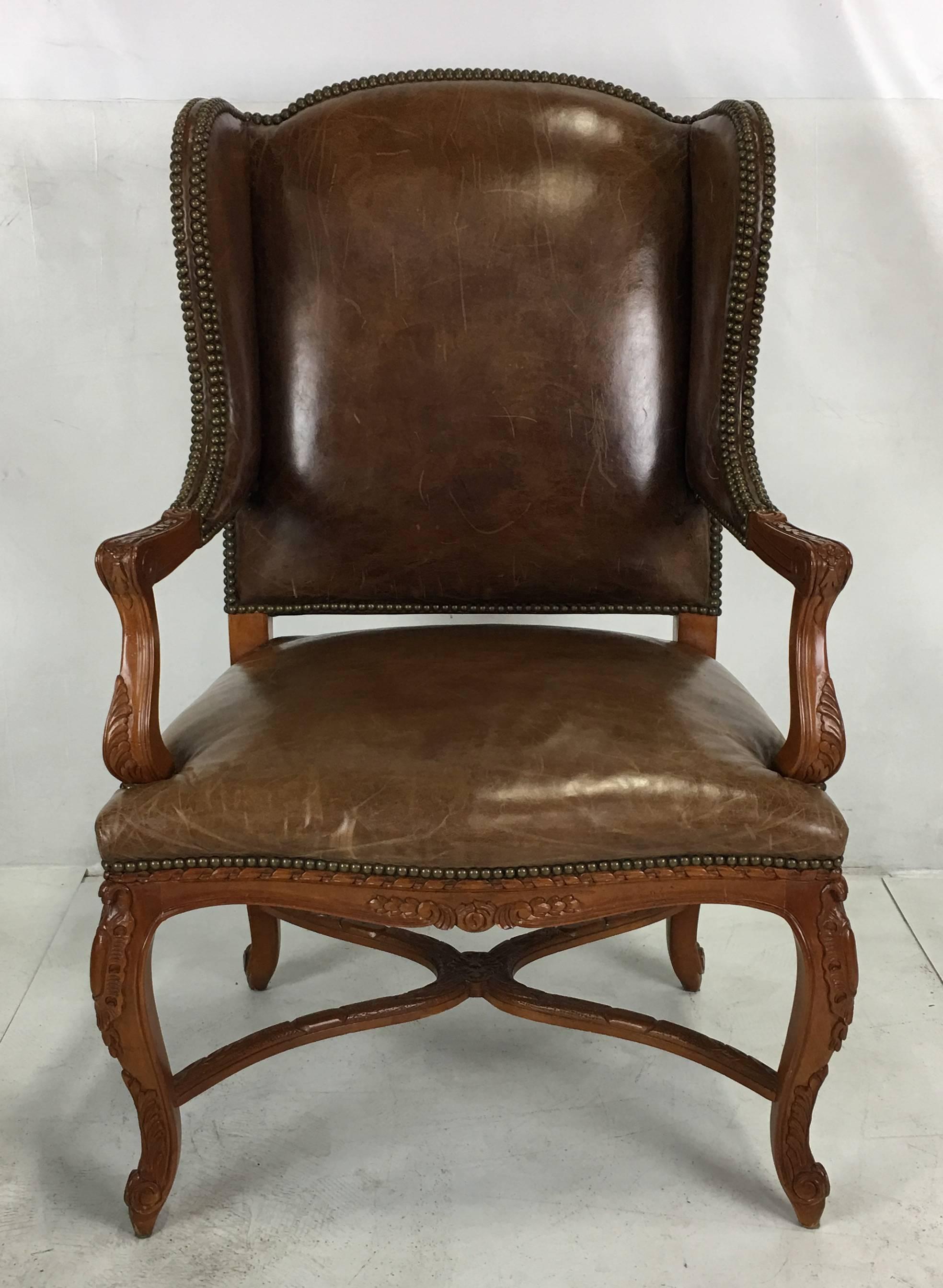 Wonderful Ralph Lauren Spencer wing chair upholstered in natural saddle leather. The frame is in perfect condition and the leather is beautifully worn. This versatile chair would work well as a desk chair or living room occasional chair.