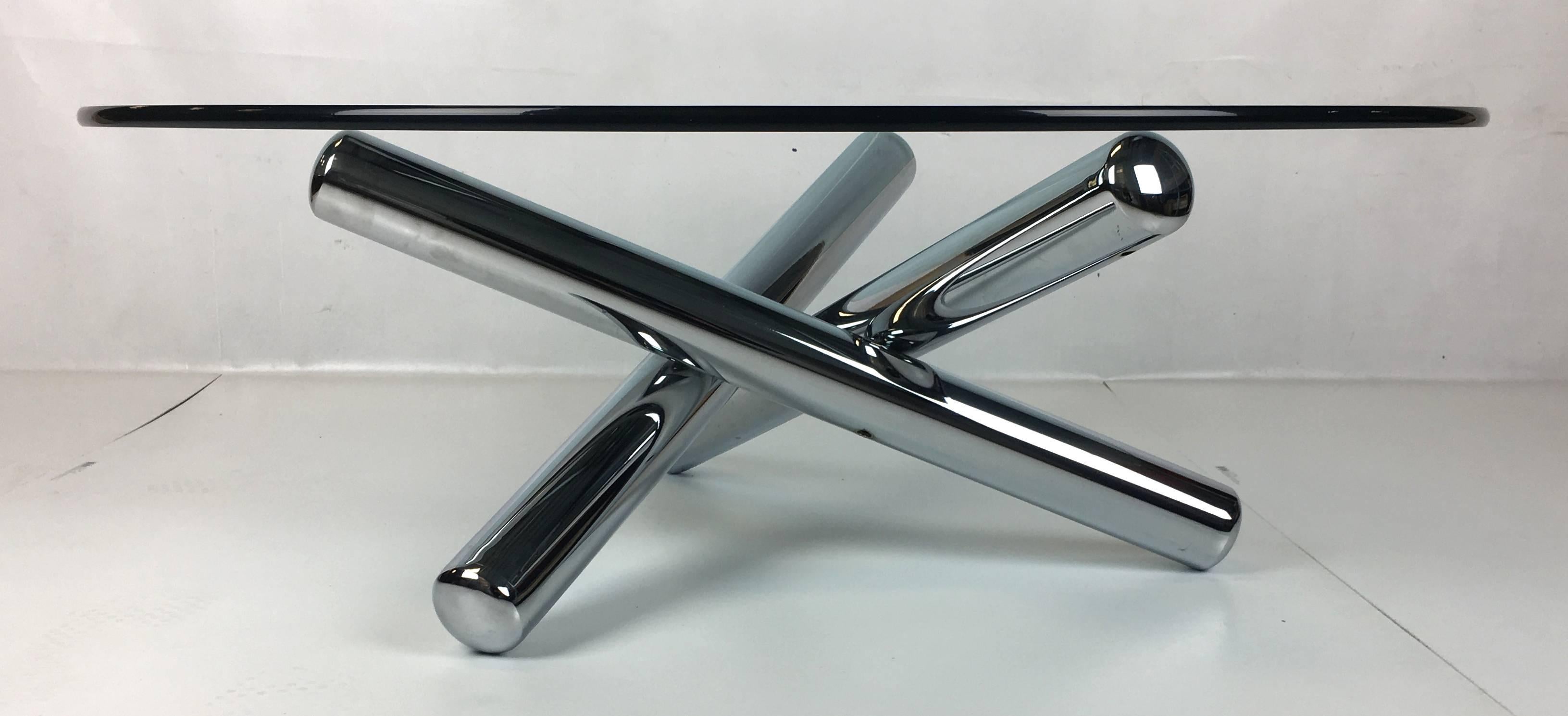 Cool sculptural chrome cocktail table consisting of three "Tubo" style elements, invisibly welded to form a "Jacks" form base for its thick glass top. The plating is in mint condition with no oxidation whatsoever.  Available to