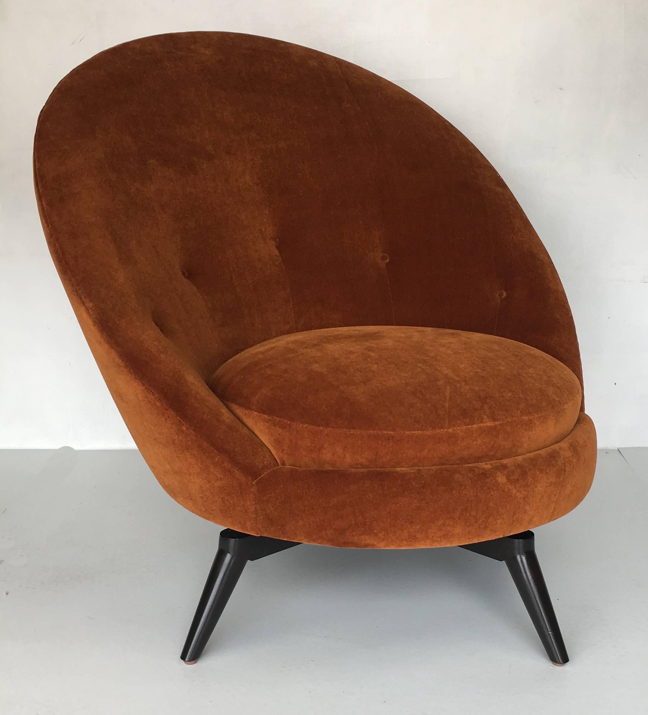 Pair of swivel egg chairs in the style of Jean Royère. The pair have been freshly upholstered in heavy-weight, backed burnt orange or rust mohair velvet. These super stylish and versatile chairs go with pretty much anything and are as comfortable as