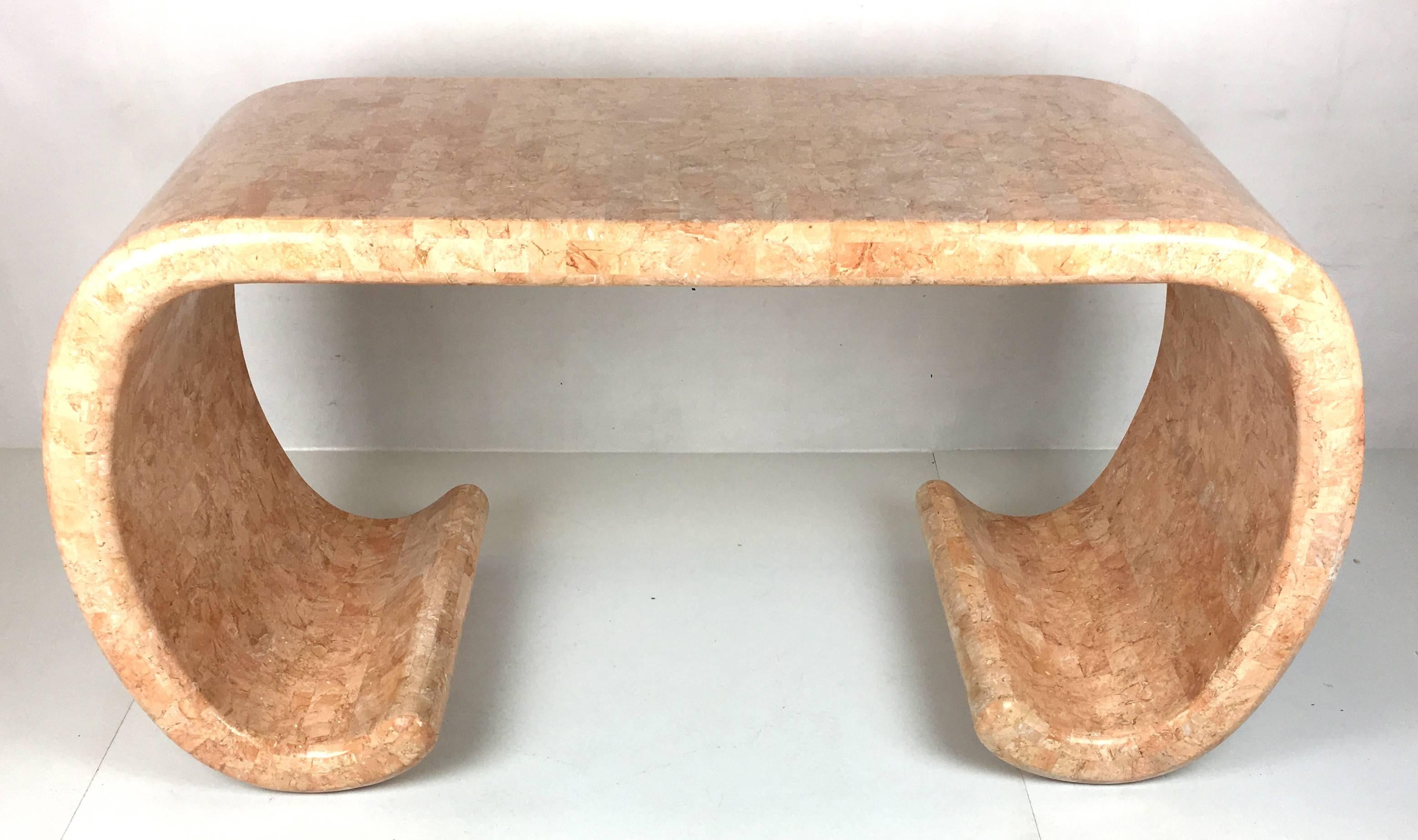 Impressive scale and quality workmanship define this waterfall writing table with scrolling base clad in tessellated fossilized coral. The desk is in excellent original condition and was used for its lifetime as a display table in a Pacific Heights