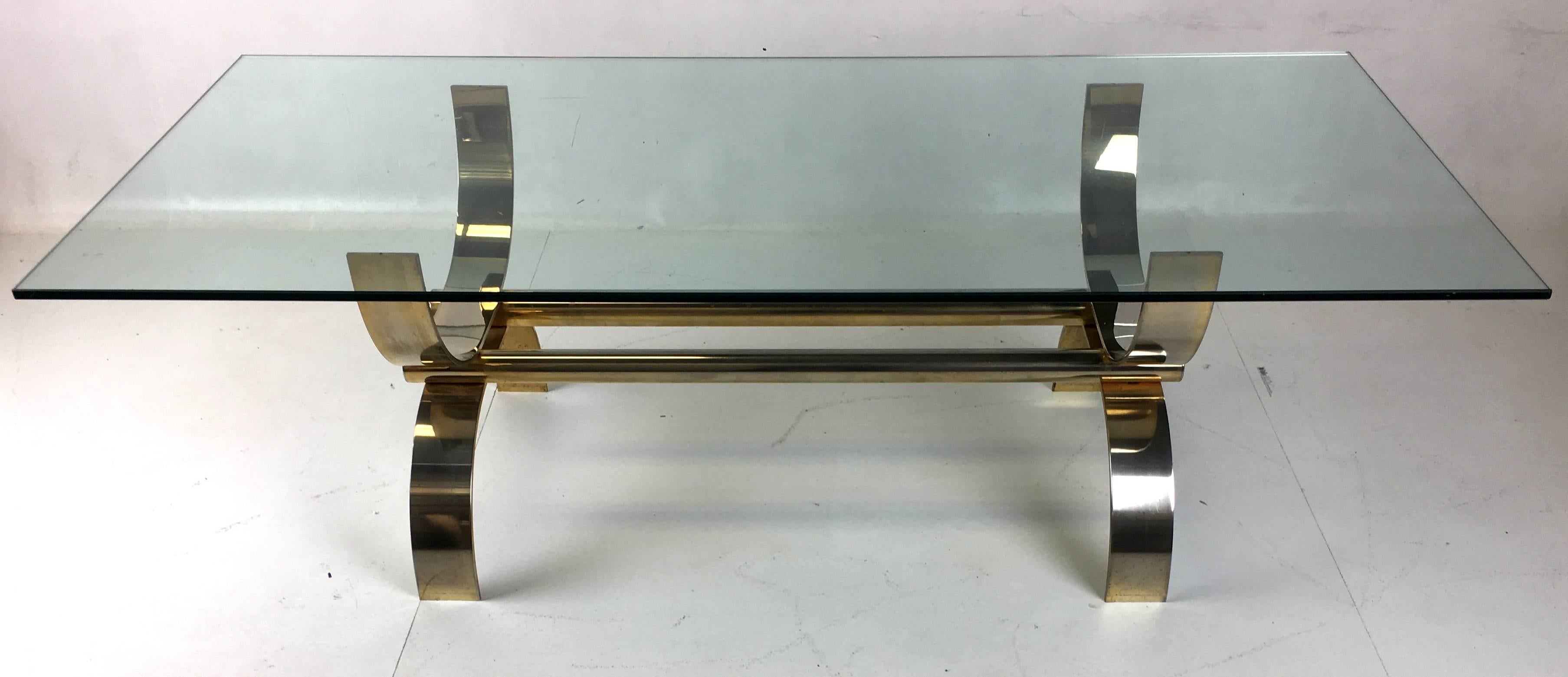 Large-scale Curule table constructed of solid brass-plated steel. The supports are 3.5