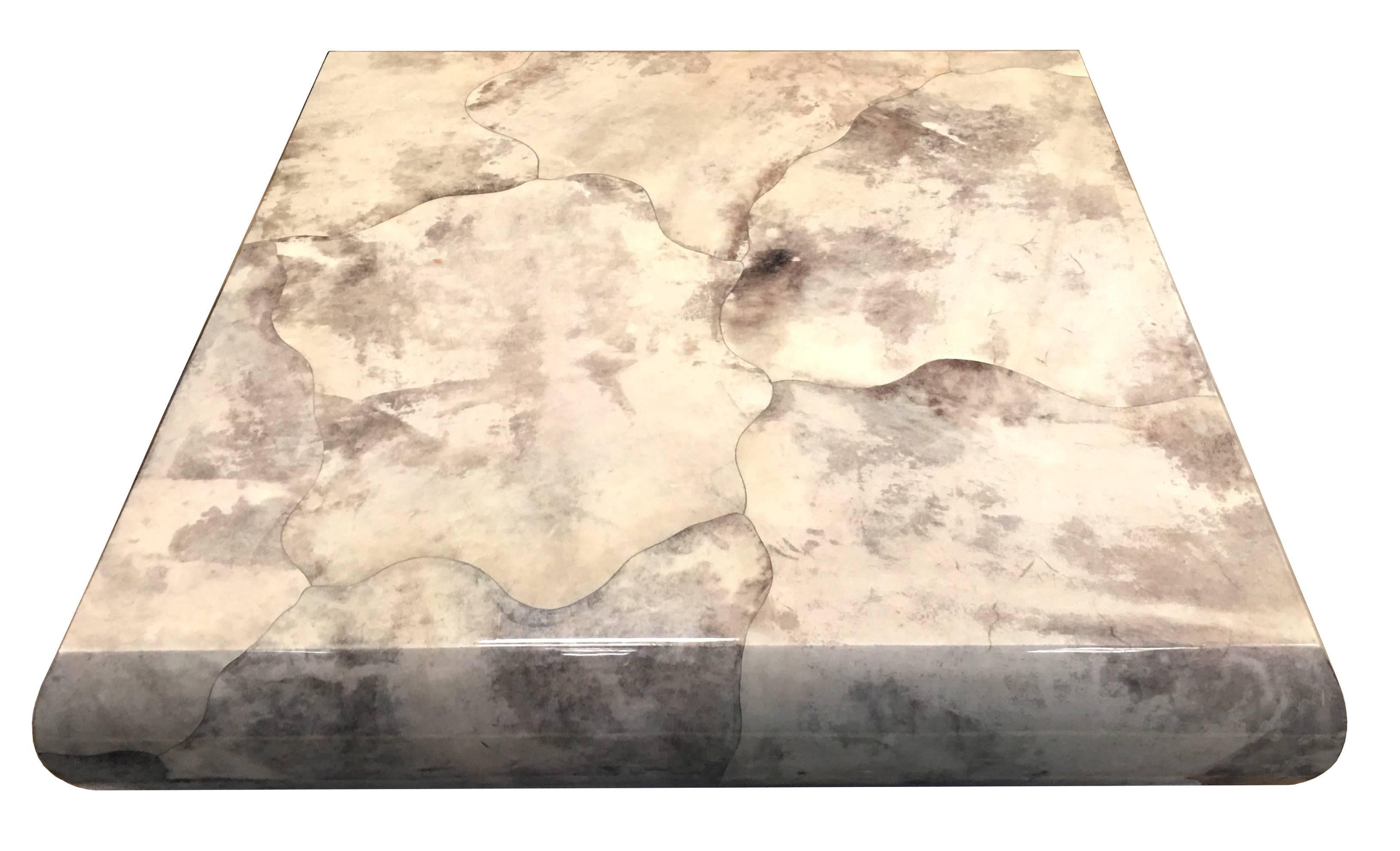 Monumental Karl Springer custom free-form pattern goatskin coffee table. The fantastically figured top is raised on a mirror polished stainless steel clad base that reflects whatever it sits on making the base virtually disappear, giving the