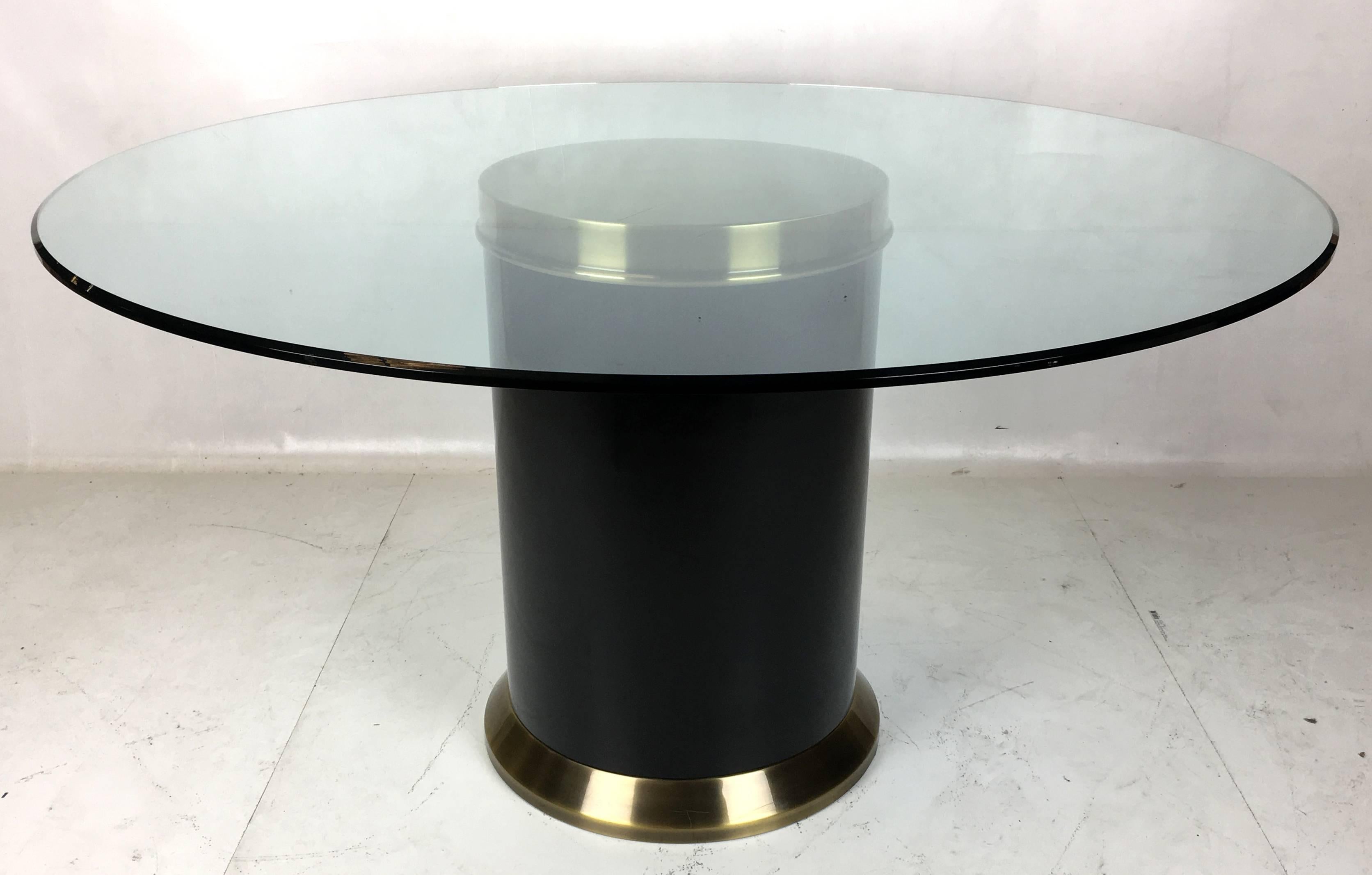 Elegant brass and black enamel dining table by Mastercraft. The beautiful brass paired with the black steel support makes an elegant, almost formal Modern statement holding a 3/4 thick polished glass top with a small chamfered top edge.

Base