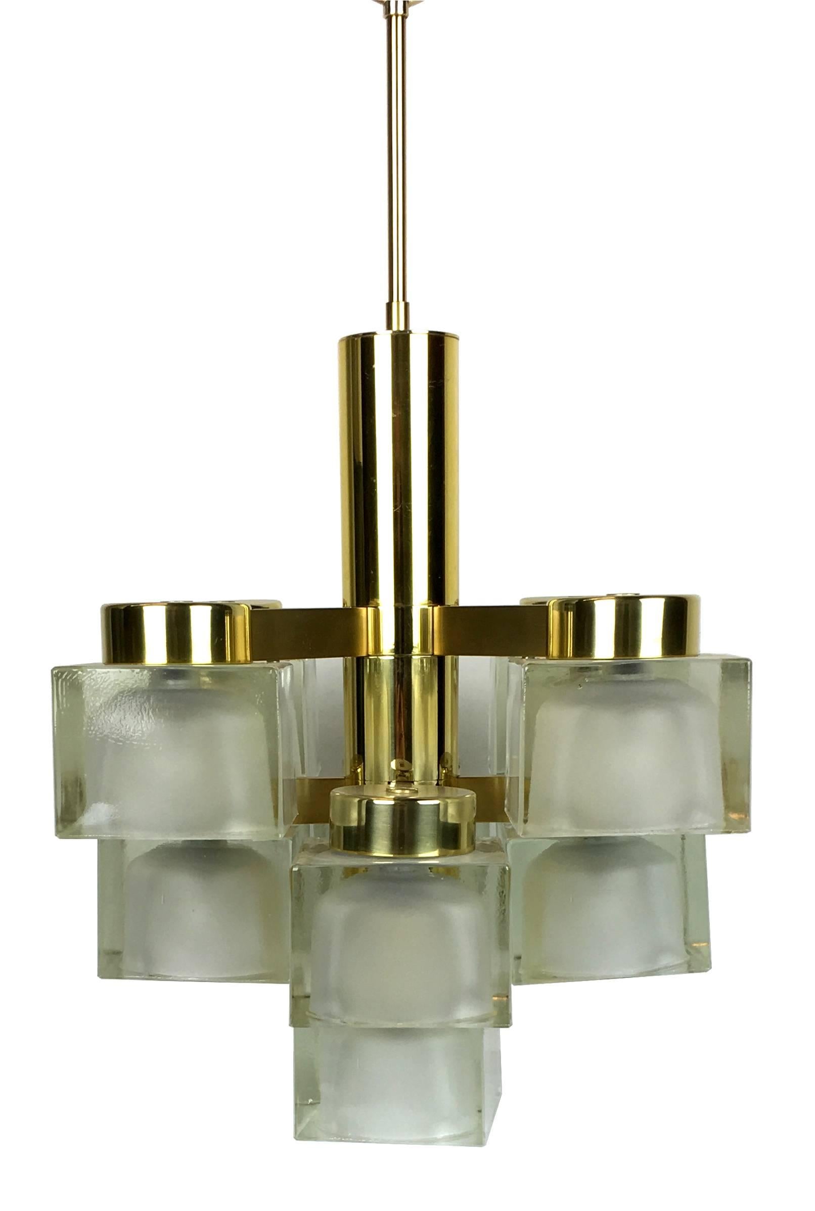 Fantastic brass chandelier with nine cast glass cube shades by Sciolari, Italy. The vintage piece is in excellent condition with virtually no wear or signs of age at all and all of the glass shades are perfect without chips or scratches. This is a